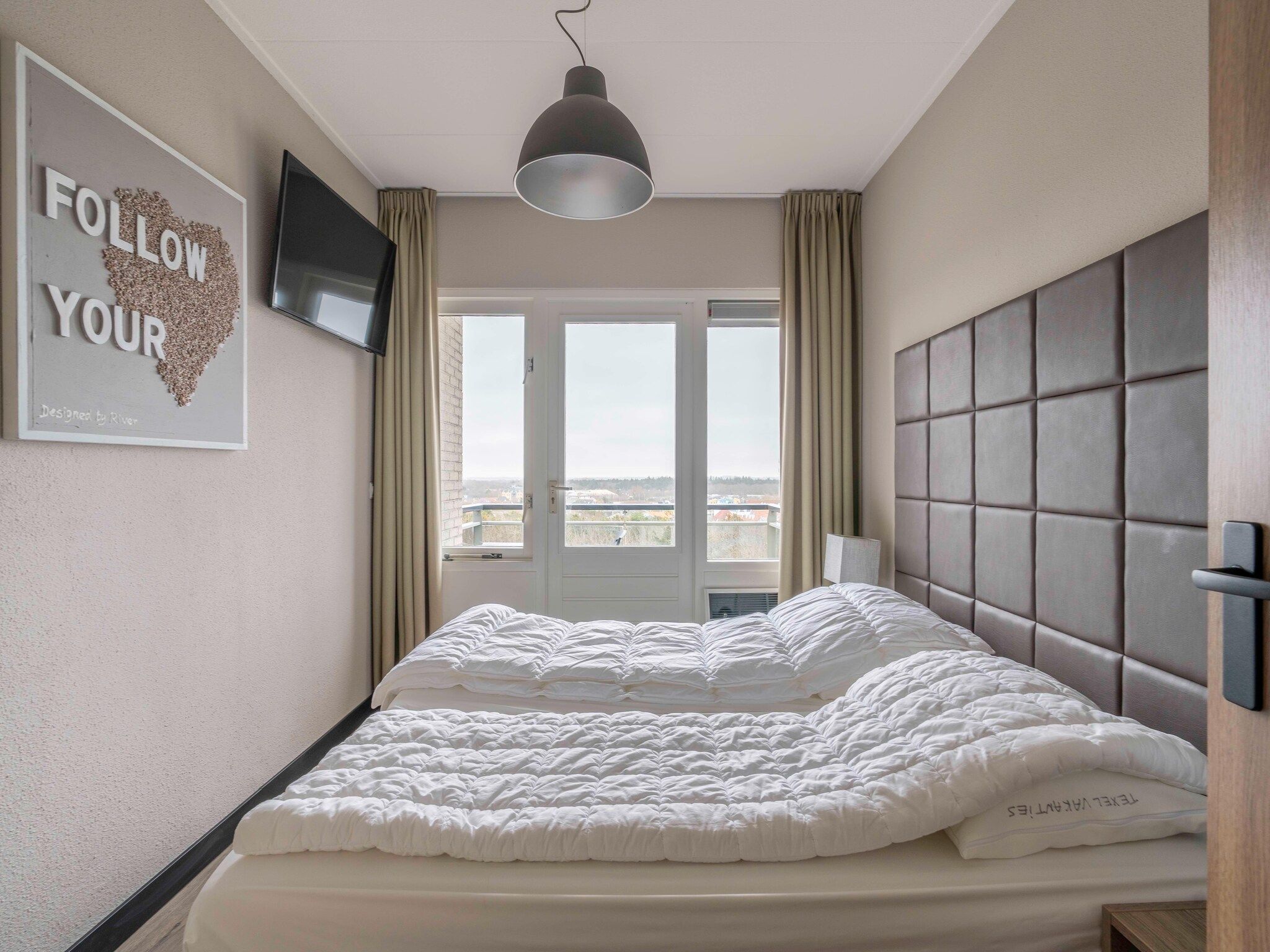 Een slaapkamer van Juliana 174 in De Koog