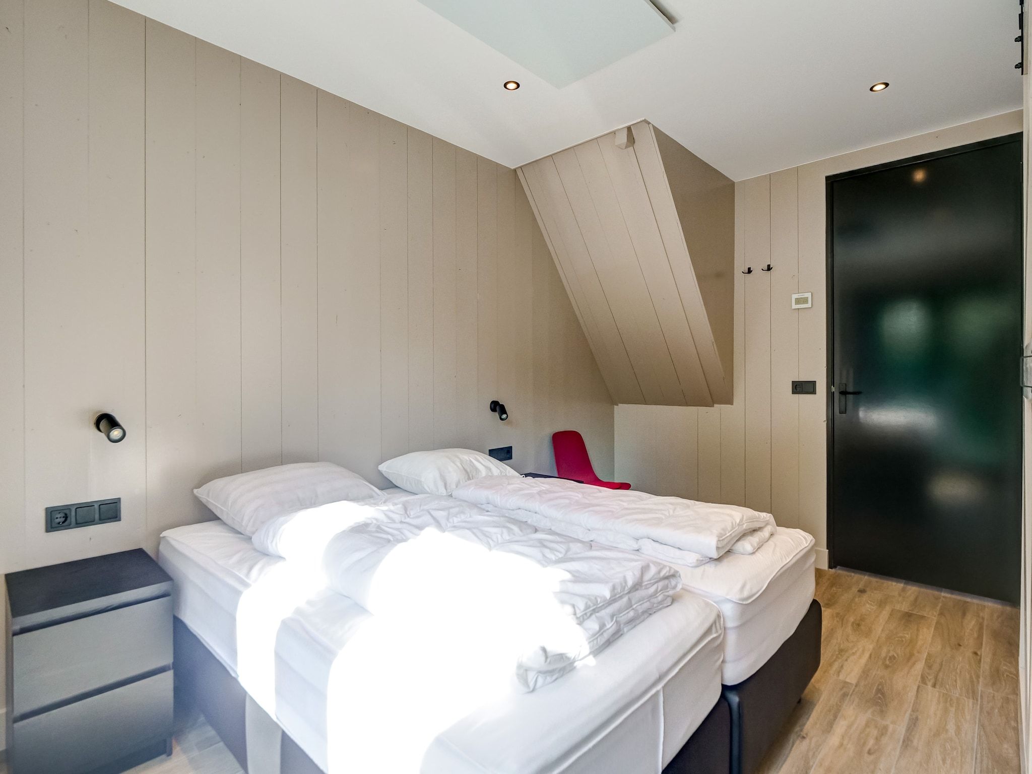 Een slaapkamer van Familiehuis Zee & Zand in Julianadorp