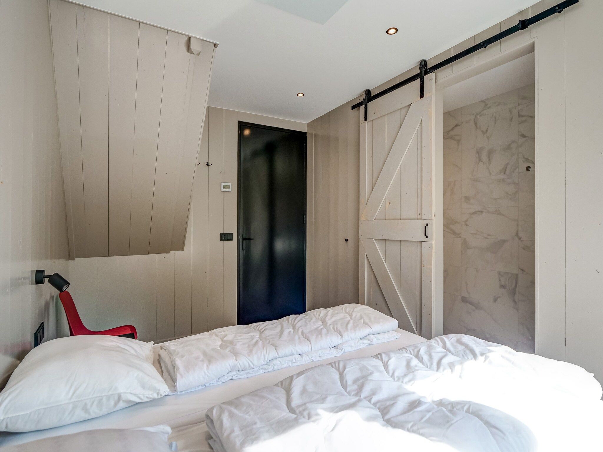 Een slaapkamer van Familiehuis Zee & Zand in Julianadorp