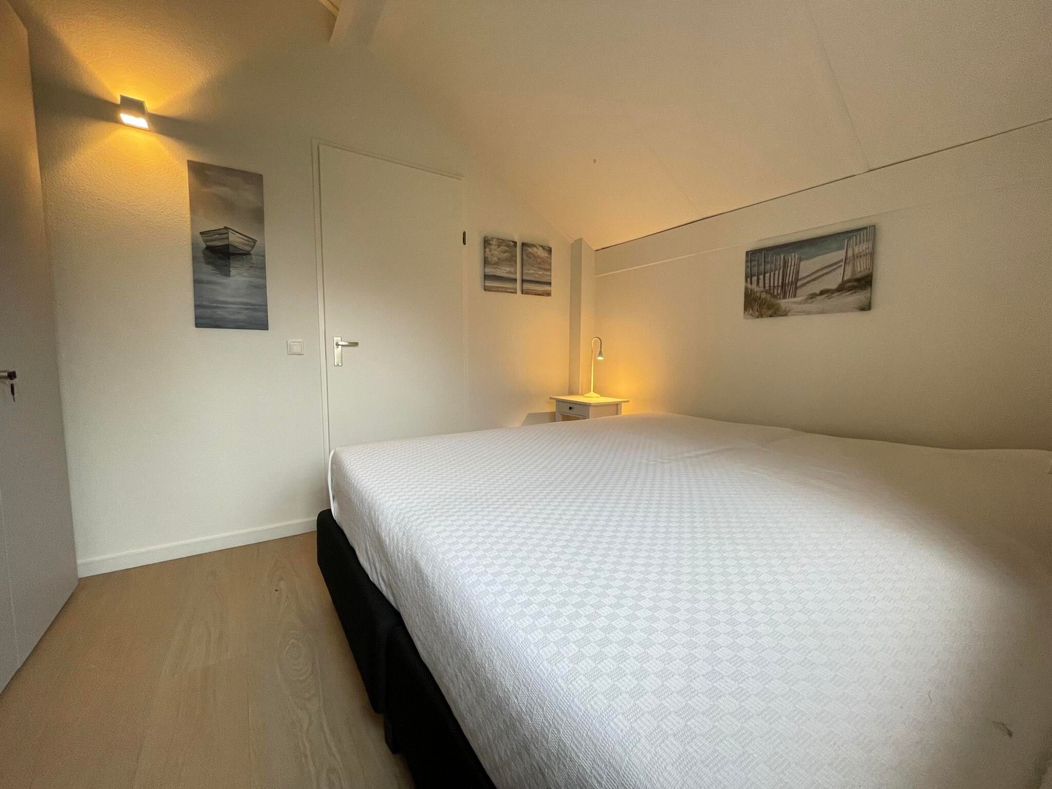 Een slaapkamer van Watervilla de Ijsvogel in Langweer