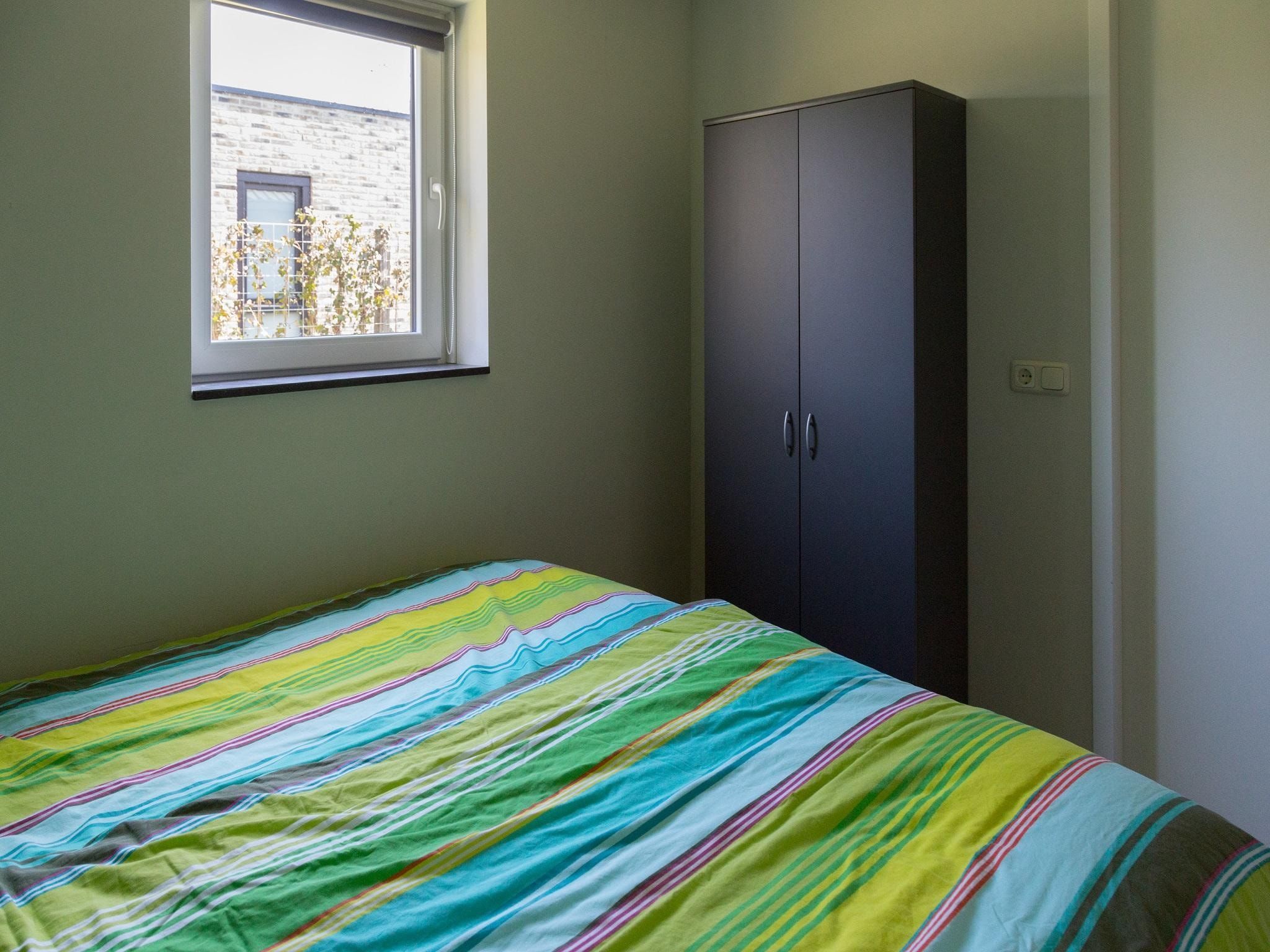 Een slaapkamer van 2 fijne Zeeuwse huisjes in Baarland