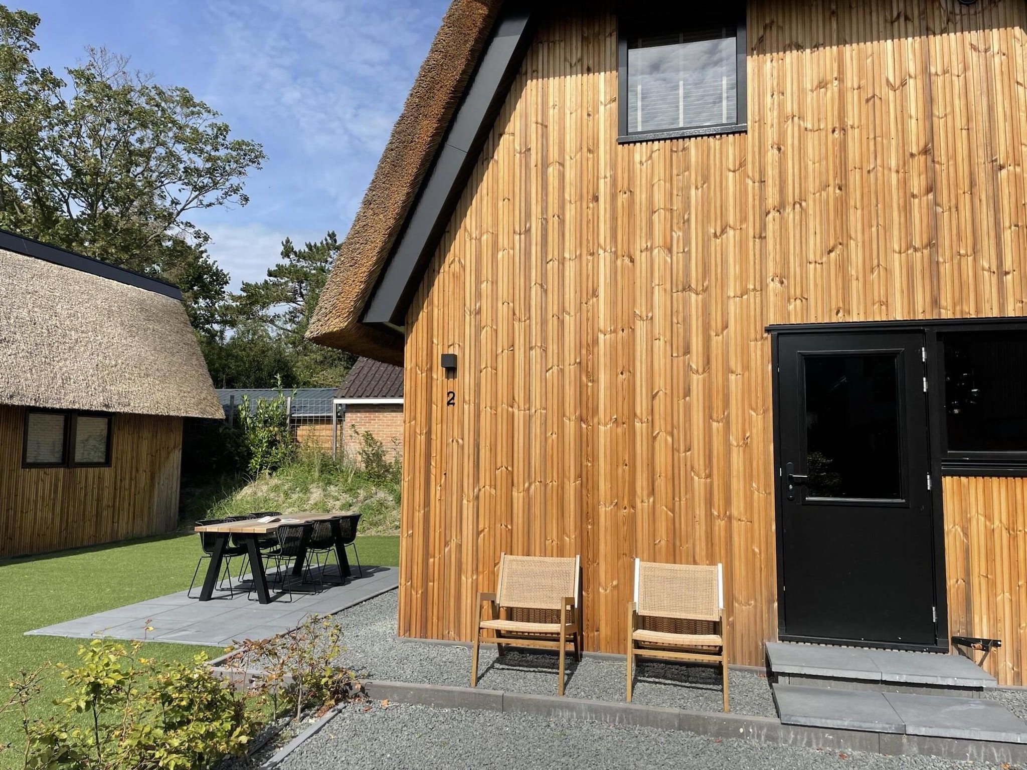 Het terras van 8-14 person group accommodation in Schoorl