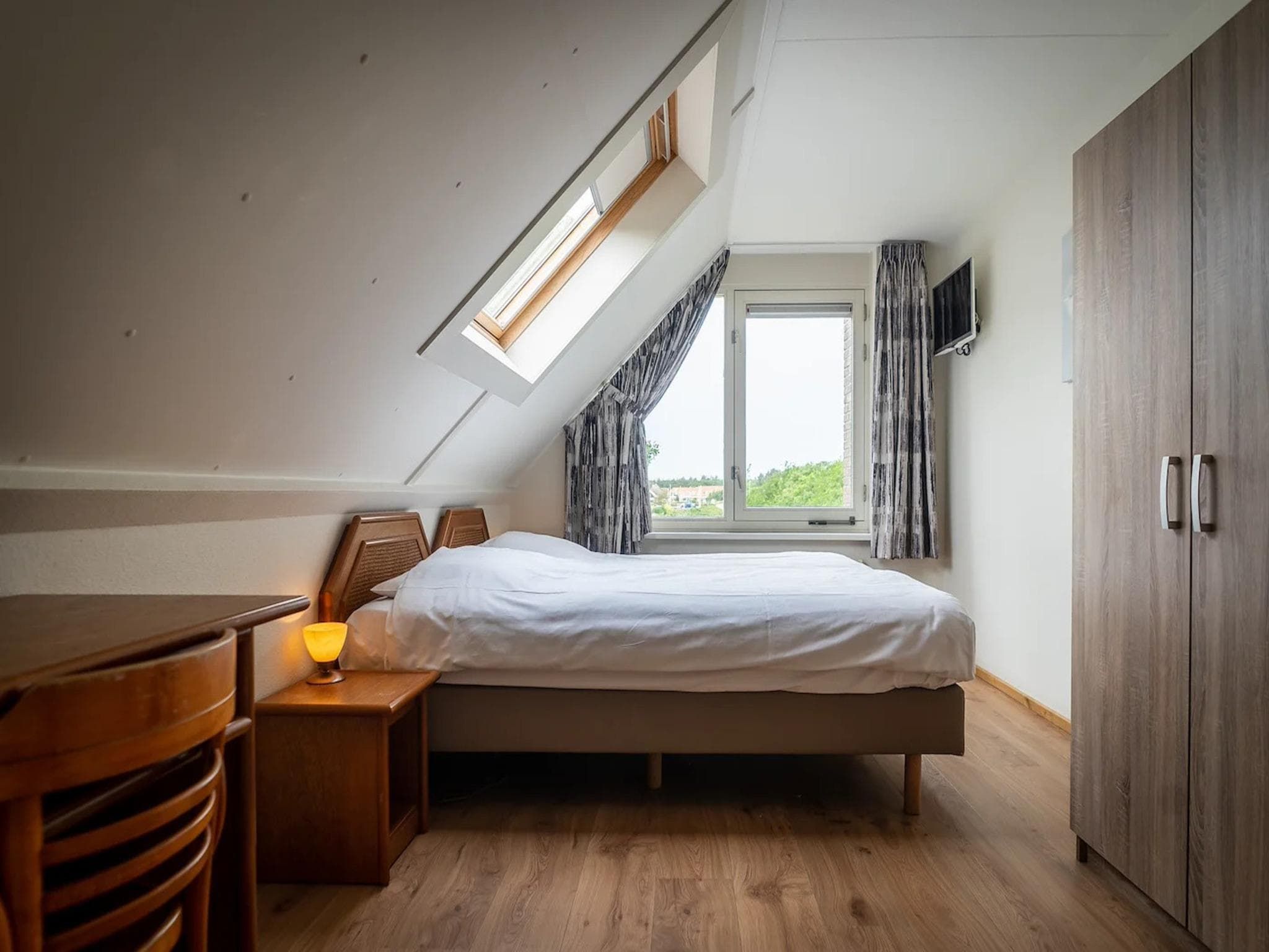 Een slaapkamer van 6-person villa in a Texel villa park in De Koog