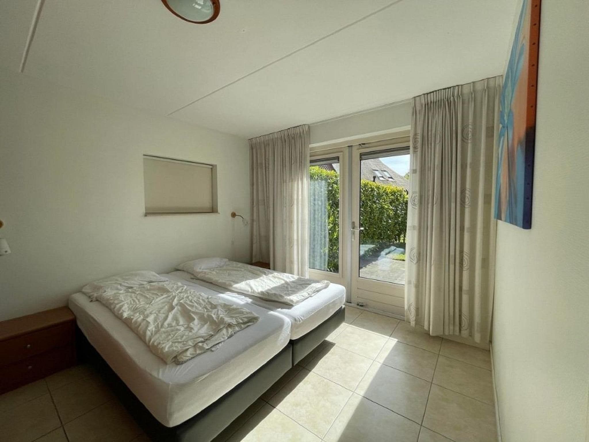 Een slaapkamer van Landgoed Eysinga State 1 in Sint Nicolaasga