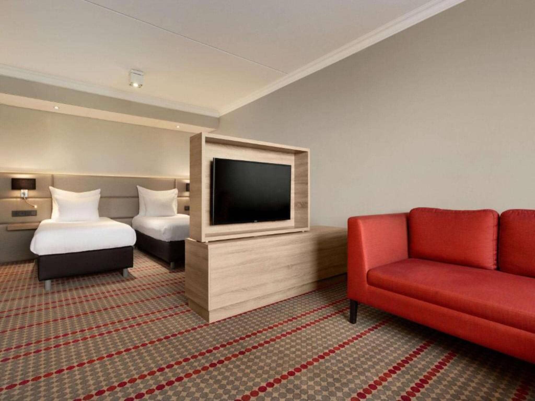 Een slaapkamer van Sunday Hotel Amsterdam Airport Schiphol in Badhoevedorp,