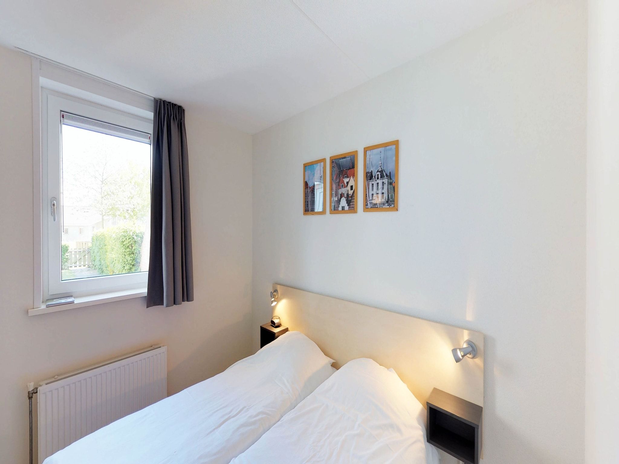 Een slaapkamer van Villapark de Paardekreek 6 in Kortgene