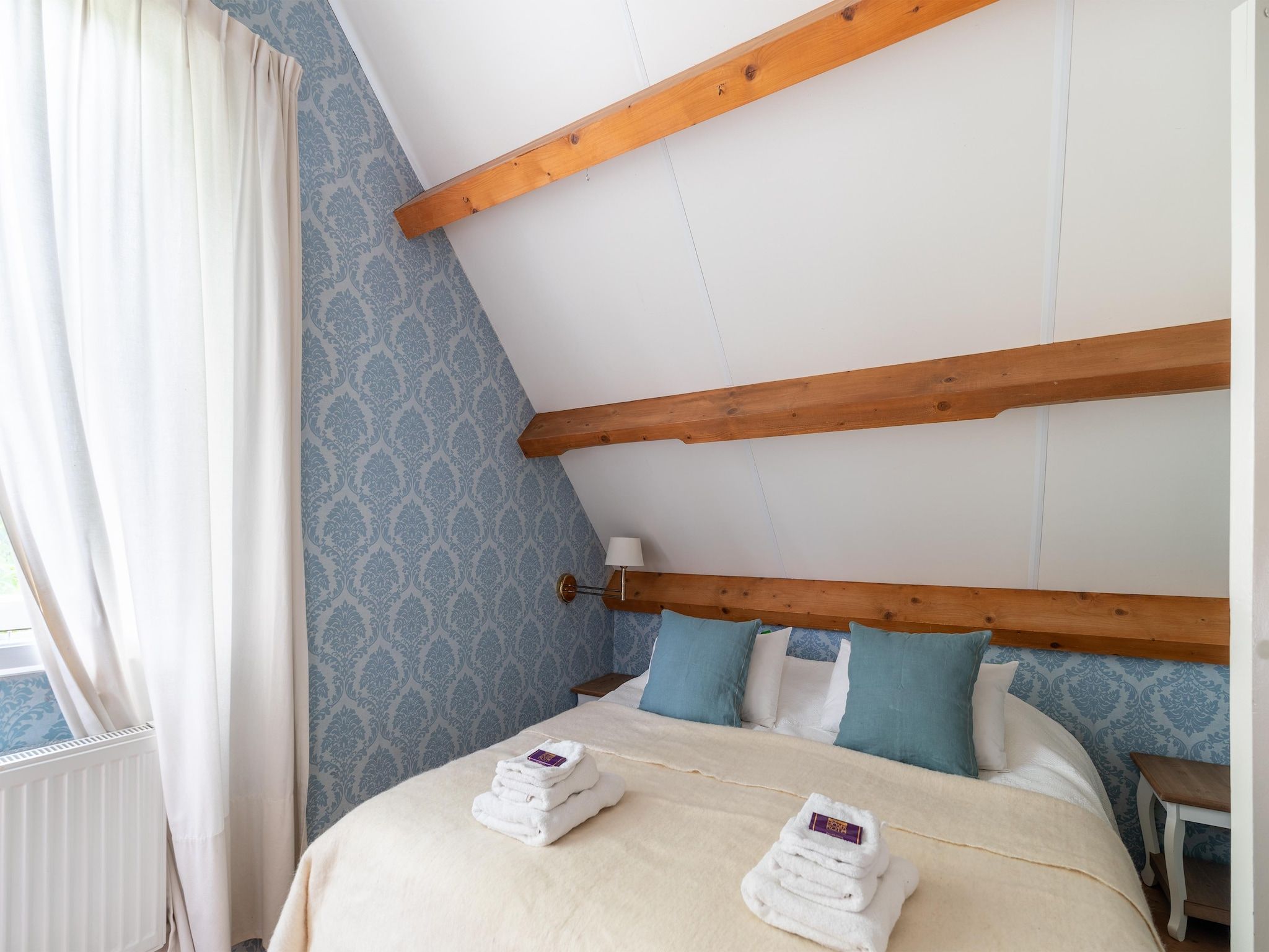 Een slaapkamer van Koetshuis 't Geyn-Landgoed Noordenhoek in Deil