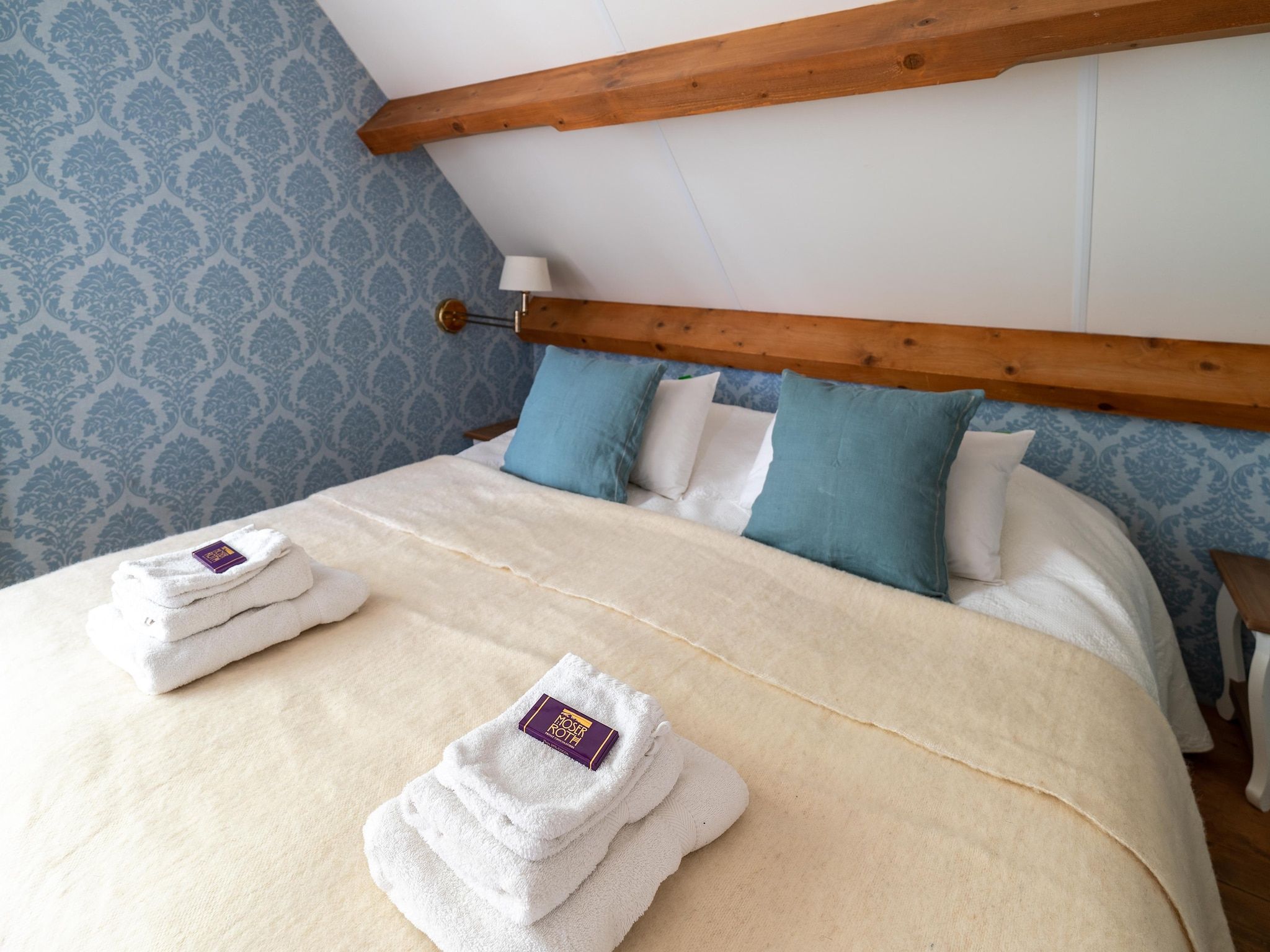 Een slaapkamer van Koetshuis 't Geyn-Landgoed Noordenhoek in Deil