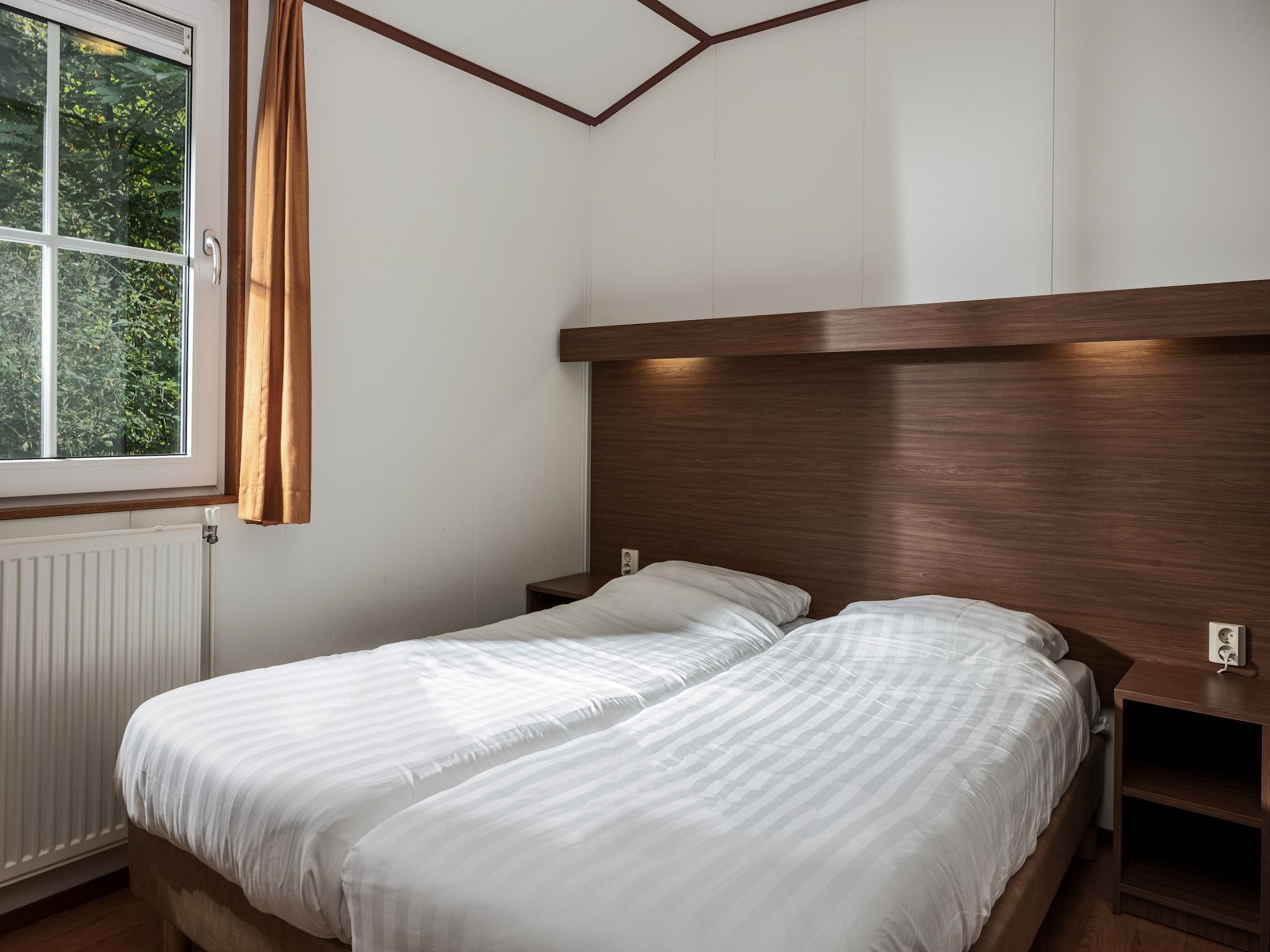 Een slaapkamer van Bospark Lunsbergen 6 in Borger