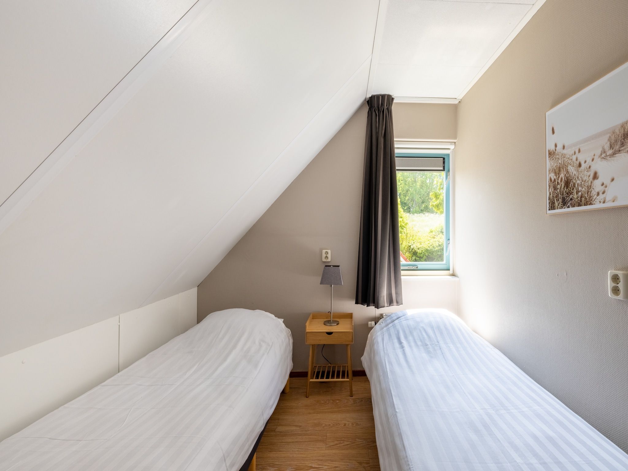 Een slaapkamer van Villavakantiepark IJsselhof 3 in Andijk