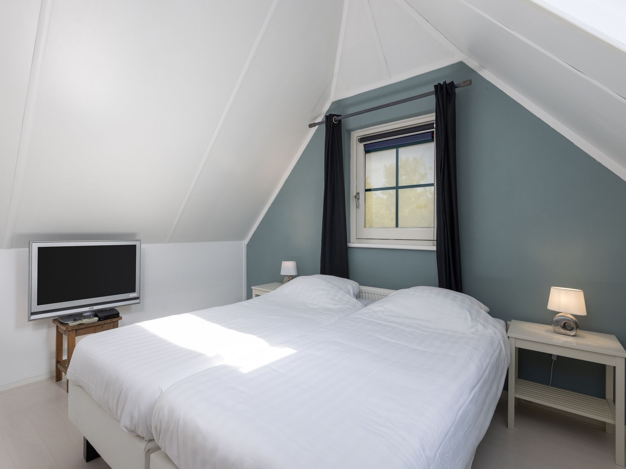 Een slaapkamer van Recreatiepark Tolplas 11 in Hoge Hexel