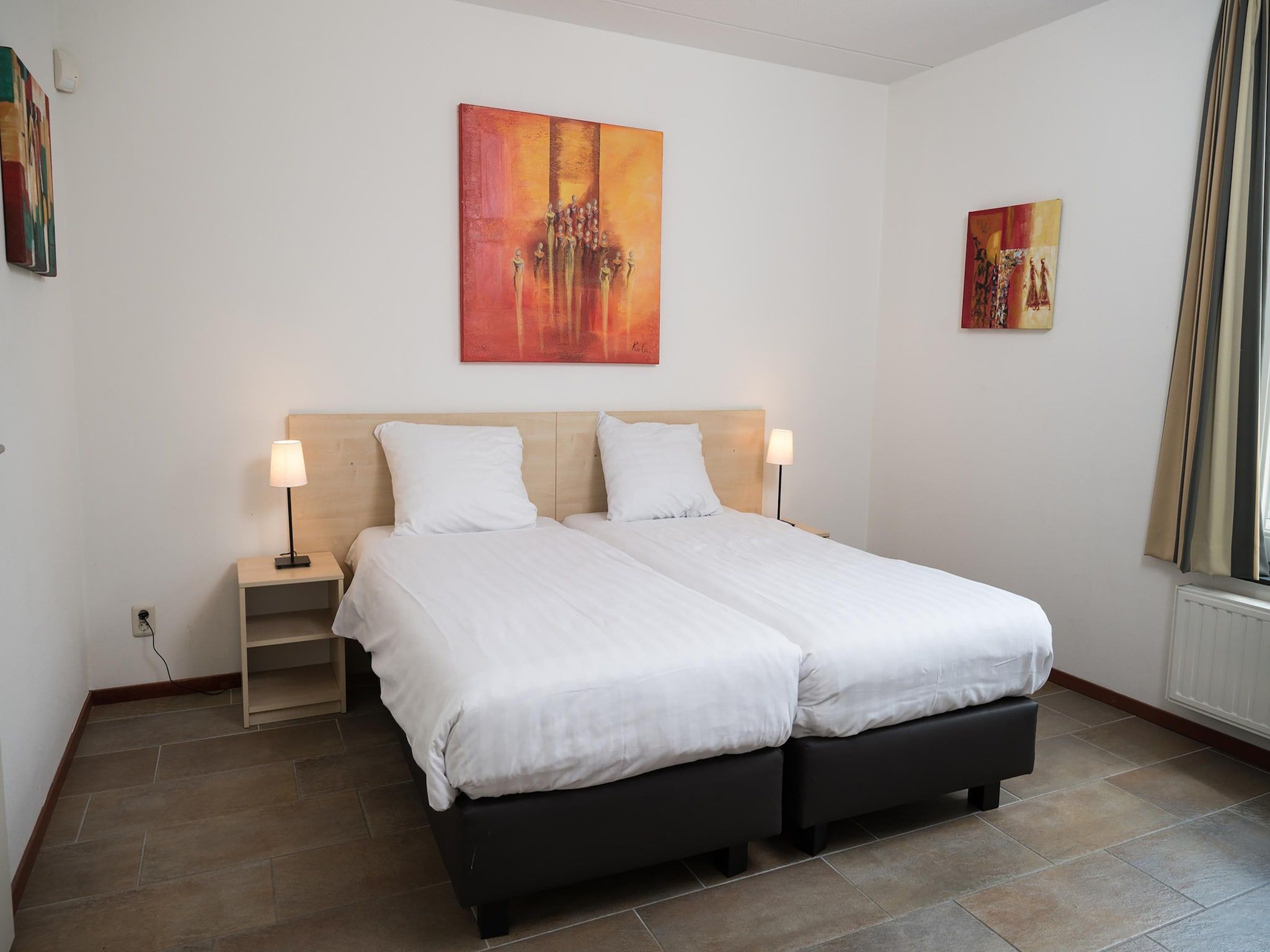 Een slaapkamer van Tuinvilla 2-6 persoons in Heel