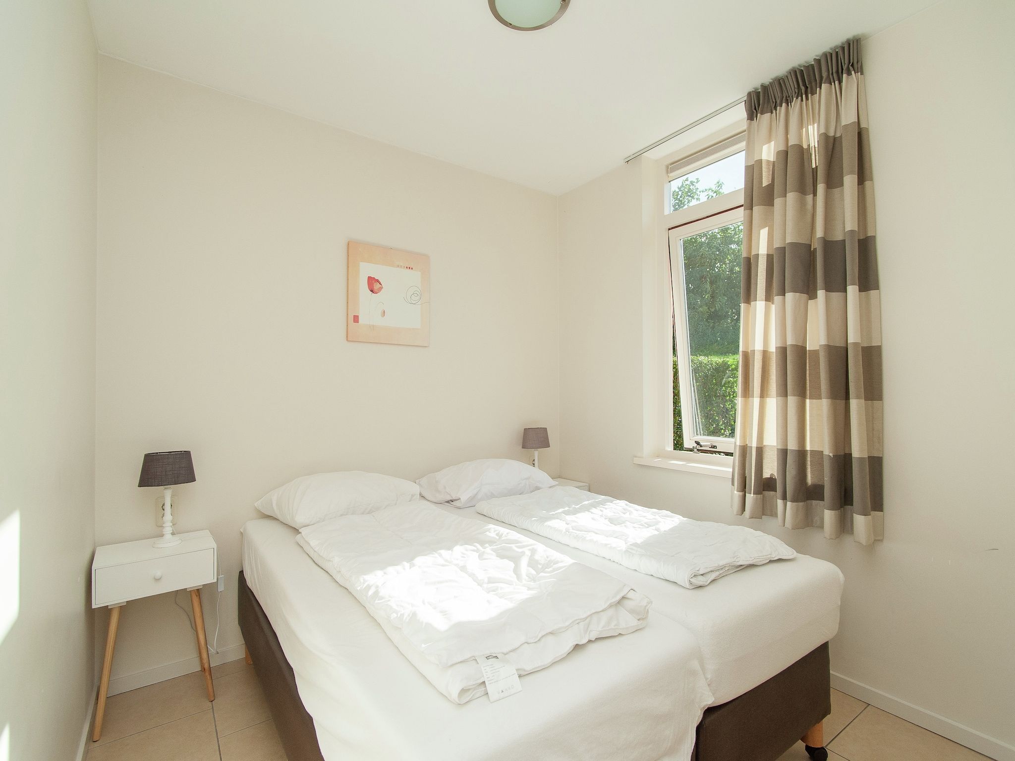 Een slaapkamer van Bungalowpark de Gouden Spar 2 in Noordwijk