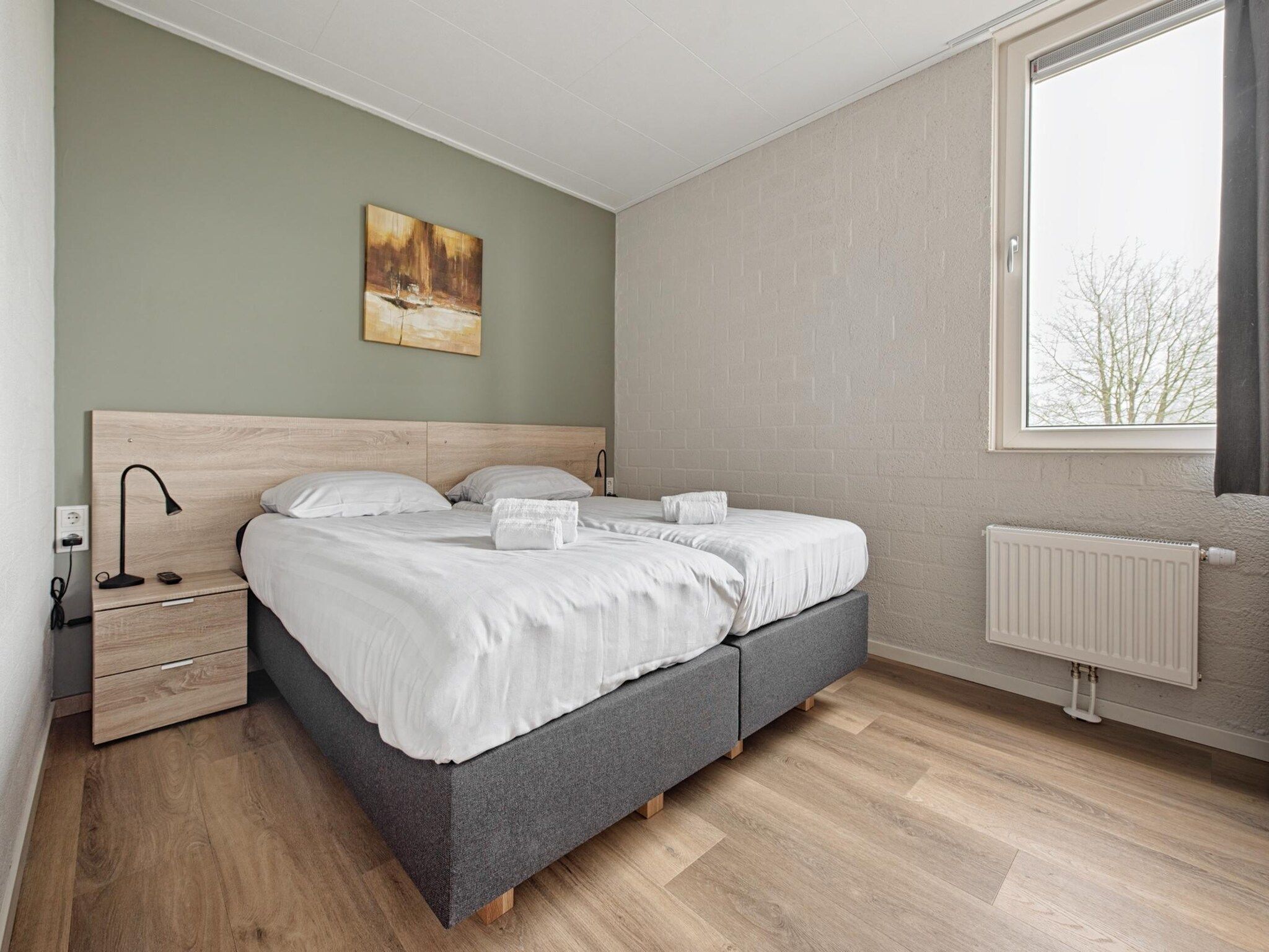 Een slaapkamer van Bungalowpark Schin op Geul 9 in Walem