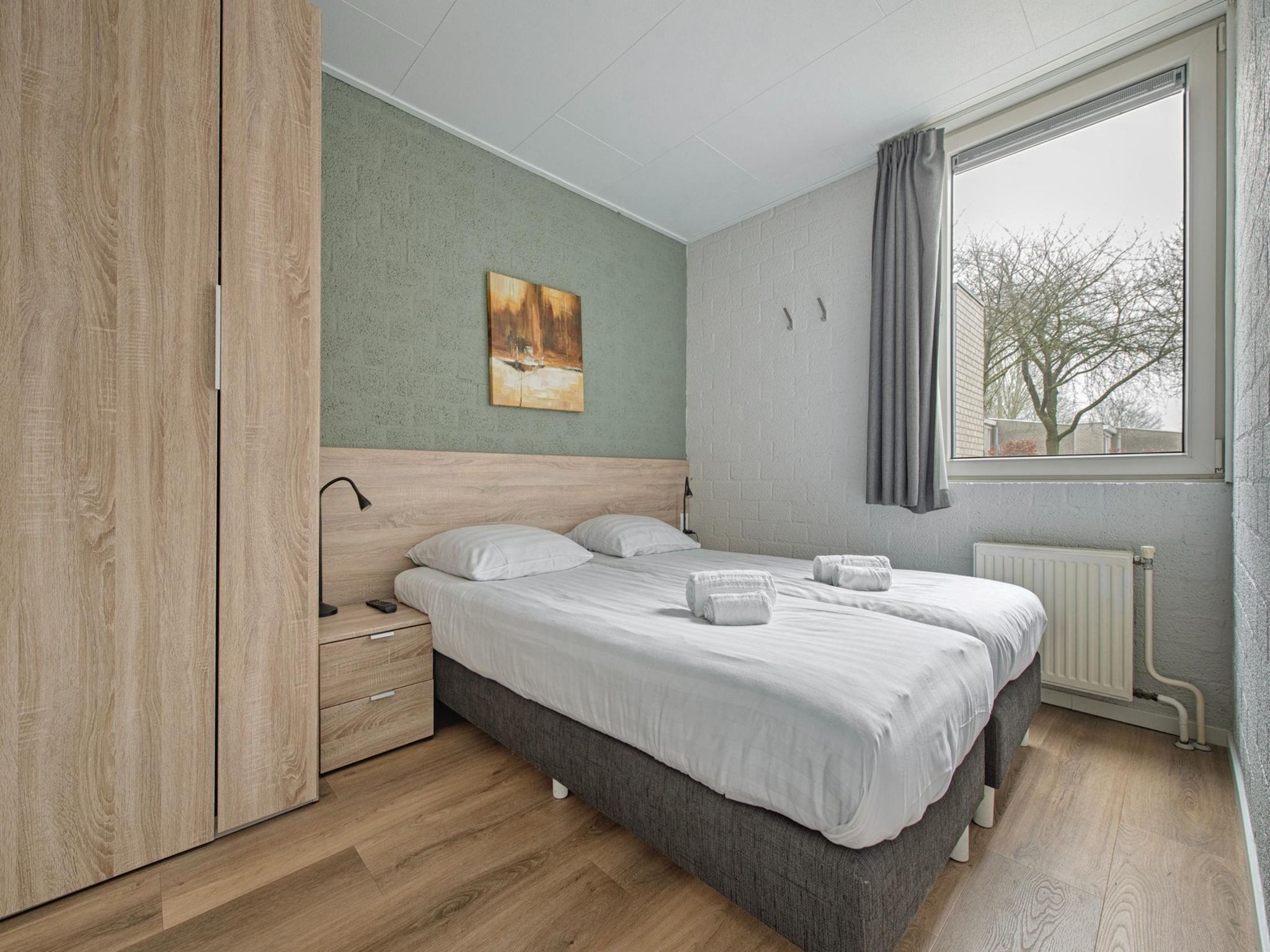 Een slaapkamer van Bungalowpark Schin op Geul 9 in Walem
