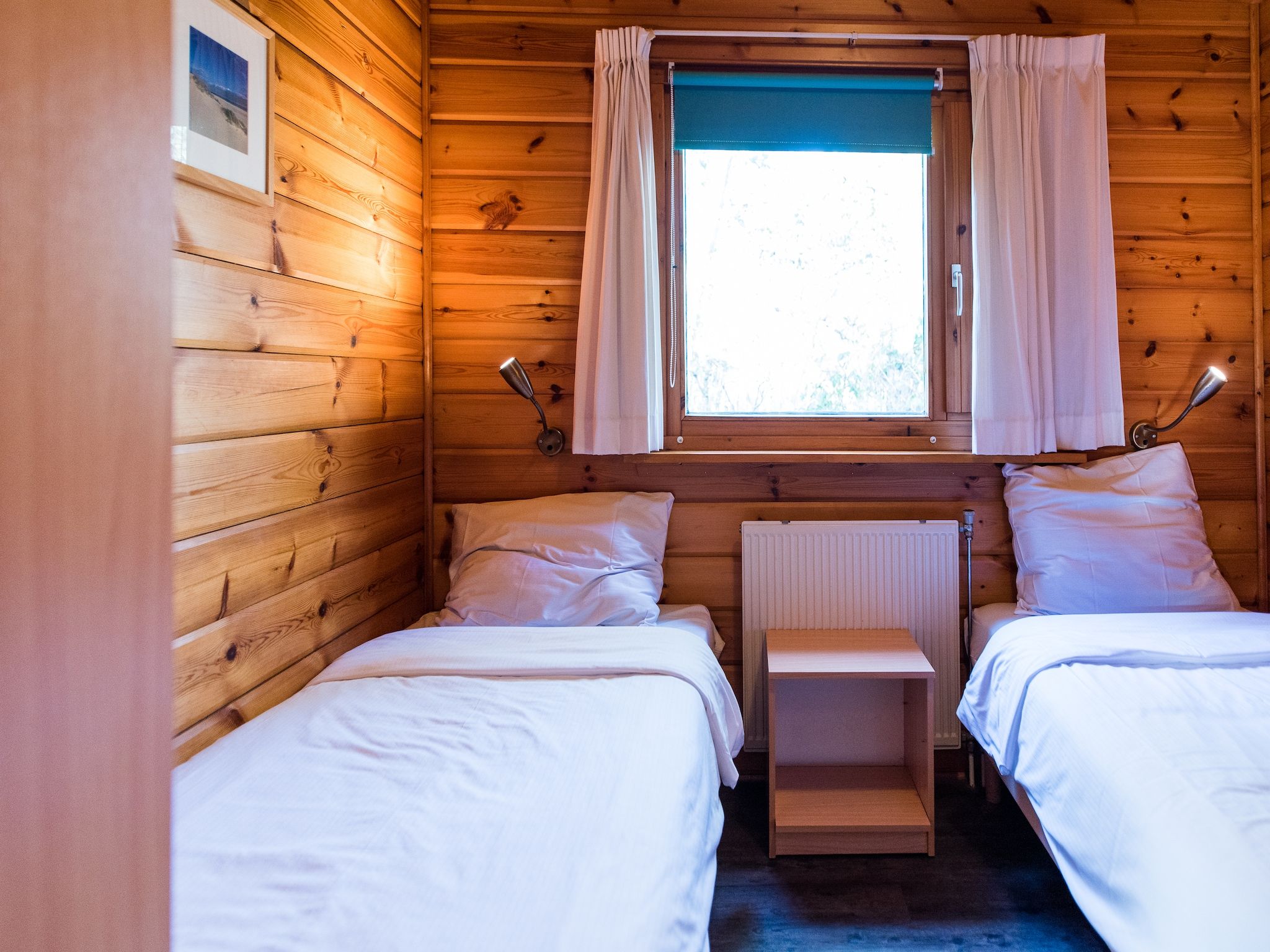 Een slaapkamer van Vakantiepark Boomhiemke 10 in Hollum