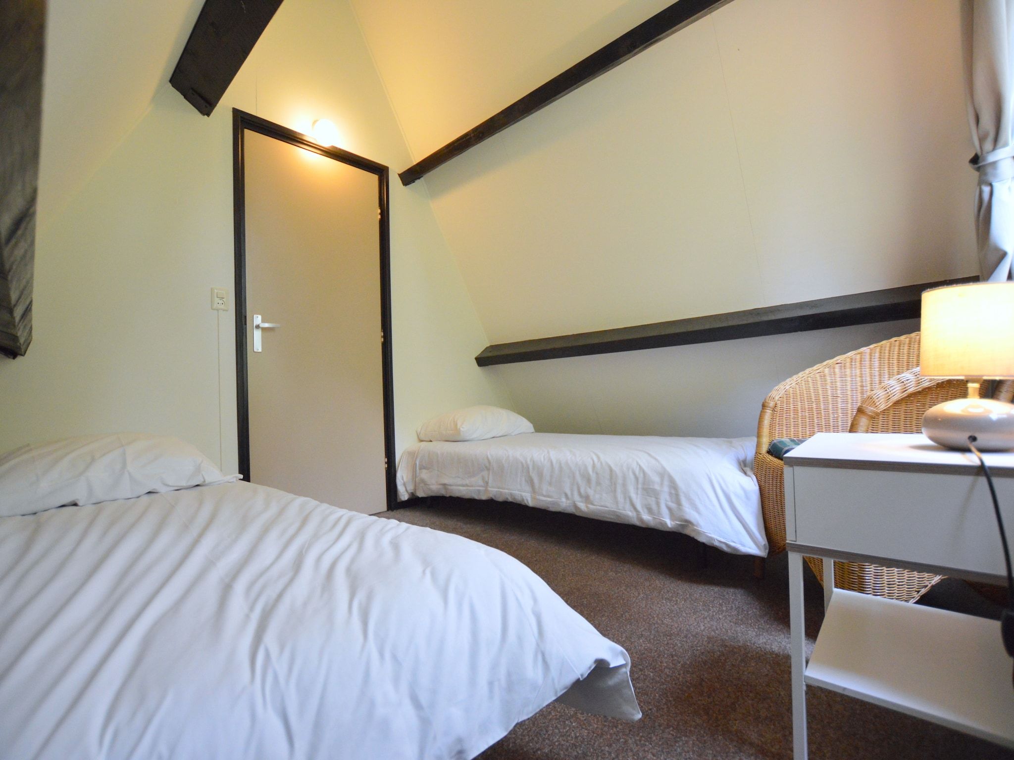 Een slaapkamer van Anjer Bungalow 61 in Stramproy