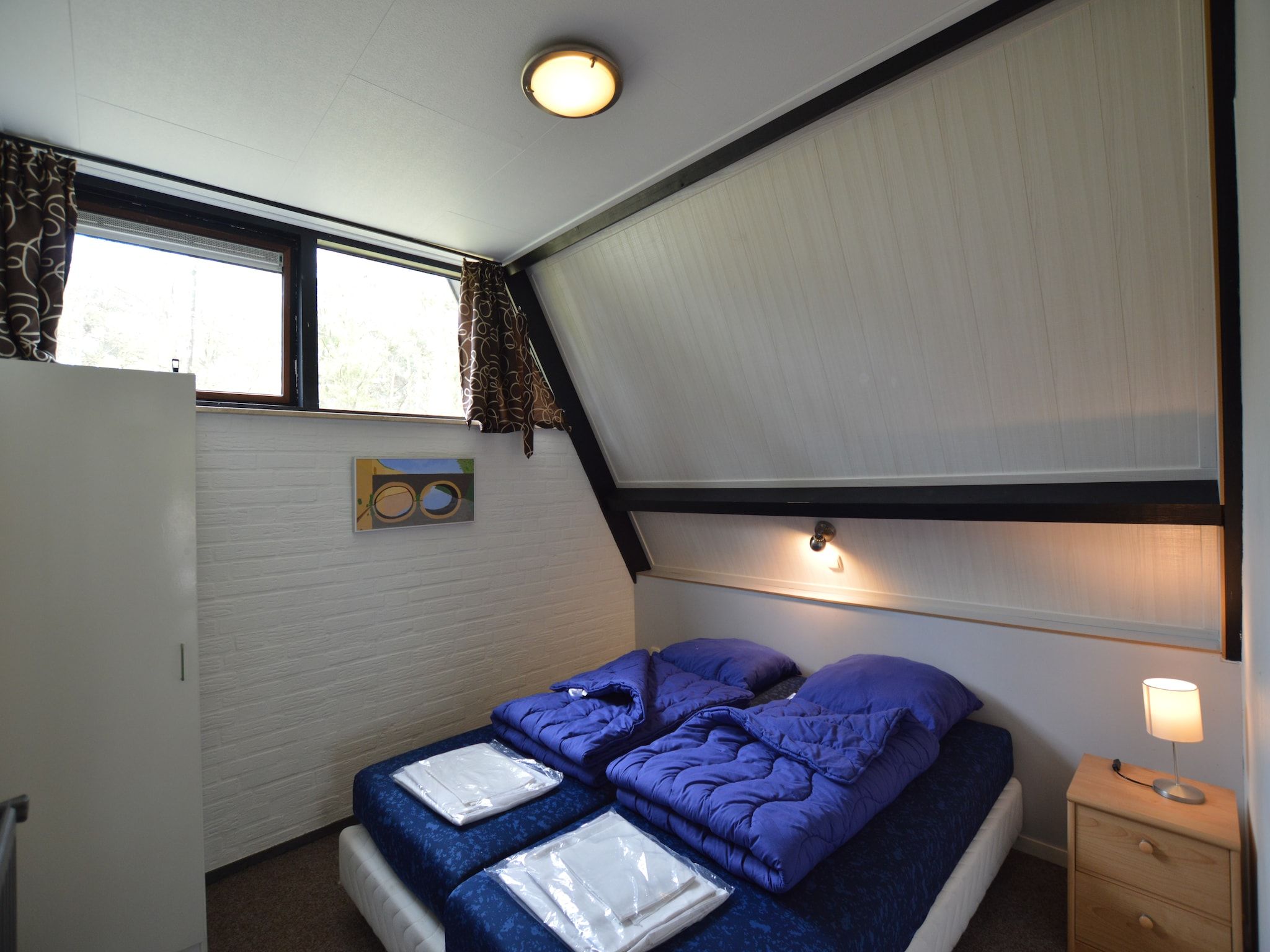 Een slaapkamer van Bungalows 48 en 49 in Stramproy