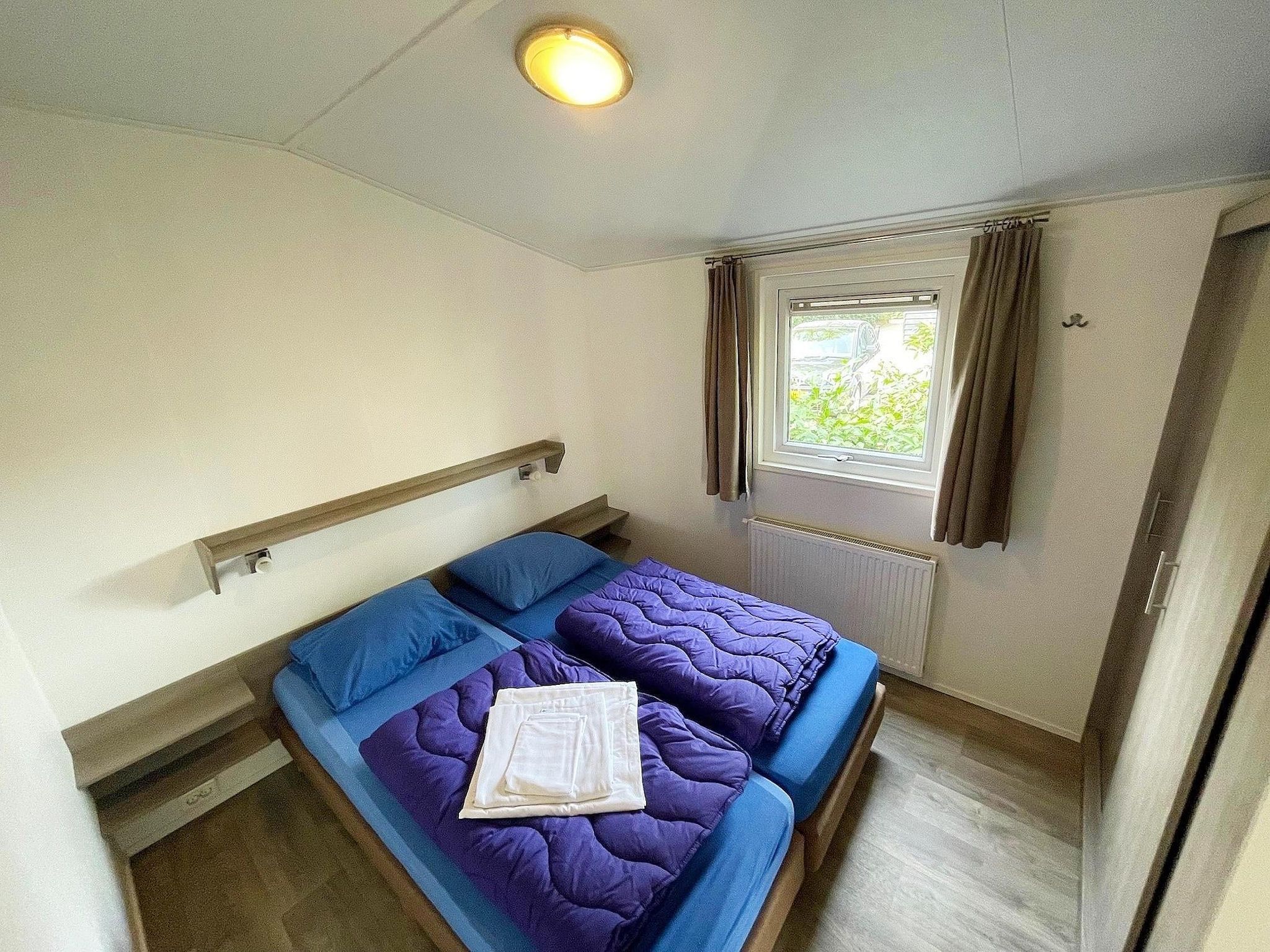 Een slaapkamer van Vakantiepark de Tabaksschuur 2 in Elst