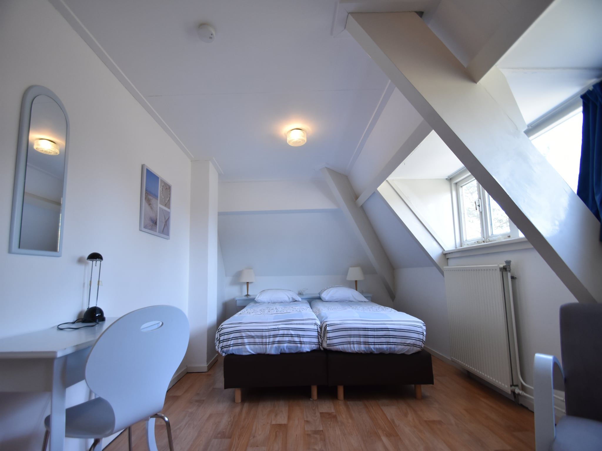 Een slaapkamer van Huize Glory Turkoois in Bergen aan Zee