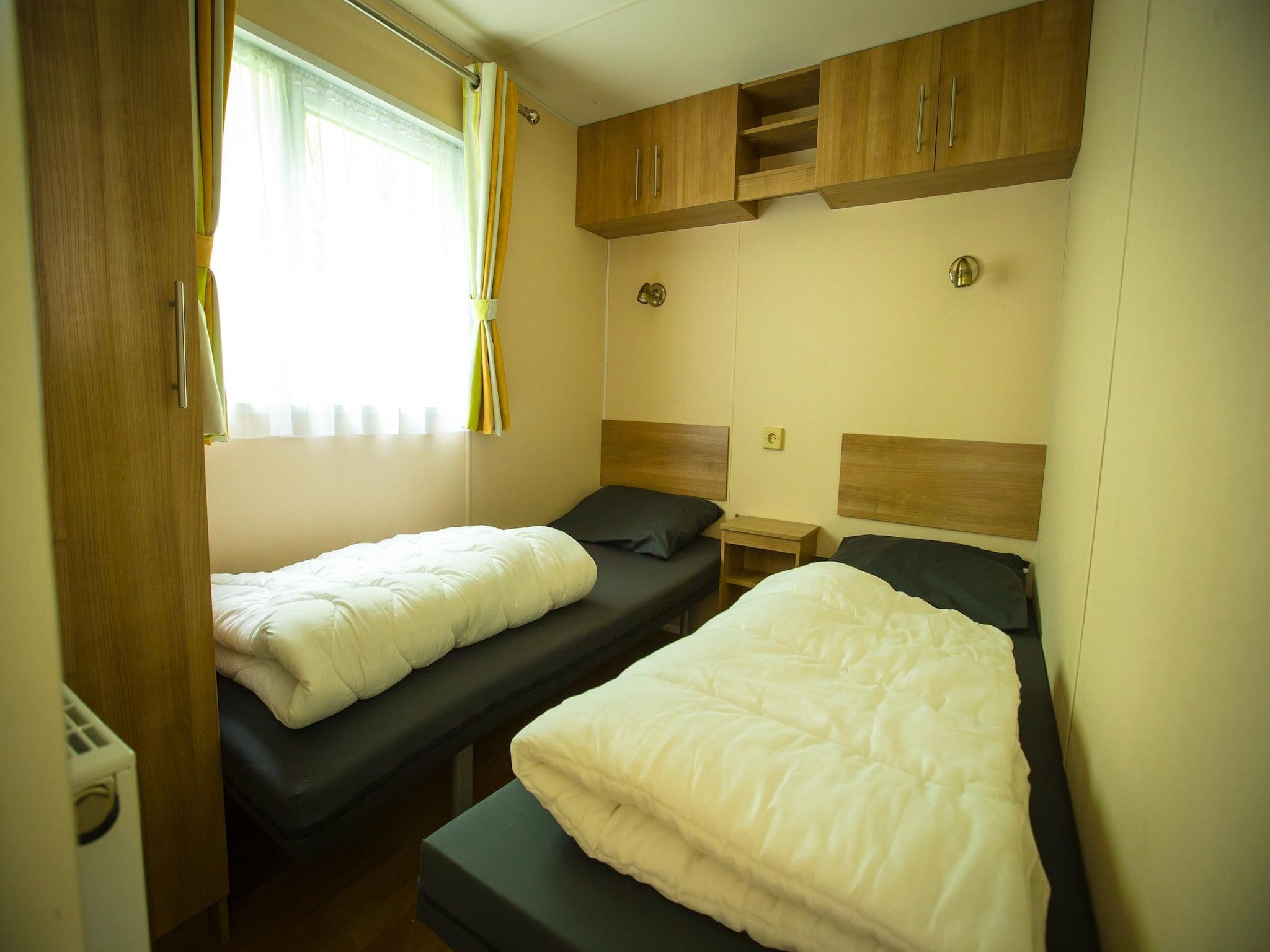 Een slaapkamer van Recreatiepark Duinhoeve 4 in Udenhout