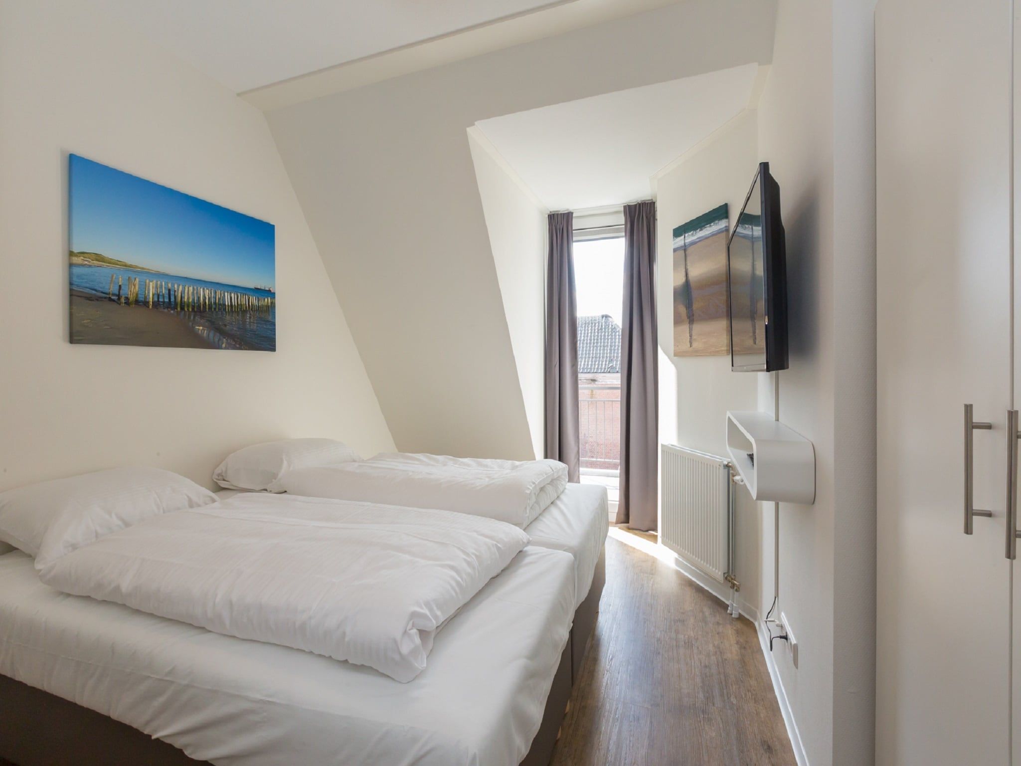 Een slaapkamer van Aparthotel Zoutelande - 4 pers luxe appartement in Zoutelande