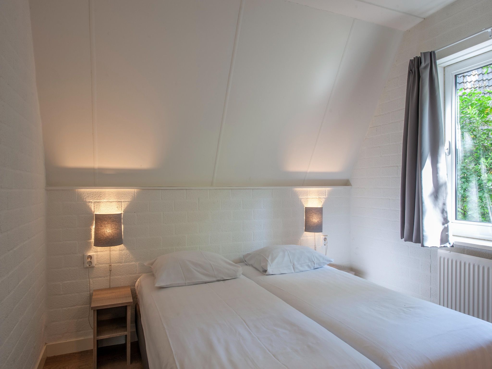 Een slaapkamer van Vakantiepark de Katjeskelder 10 in Oosterhout