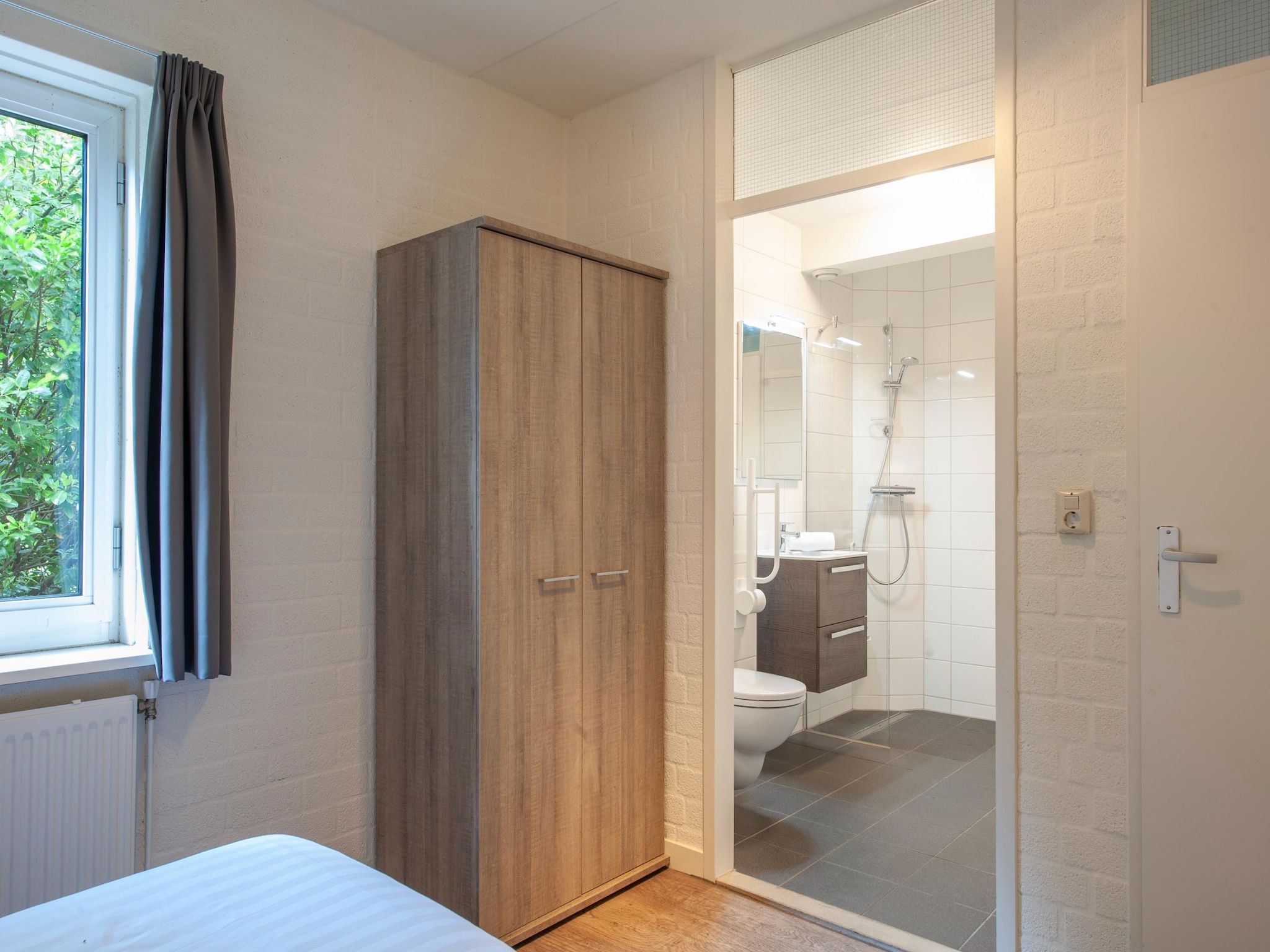 Een slaapkamer van Vakantiepark de Katjeskelder 10 in Oosterhout