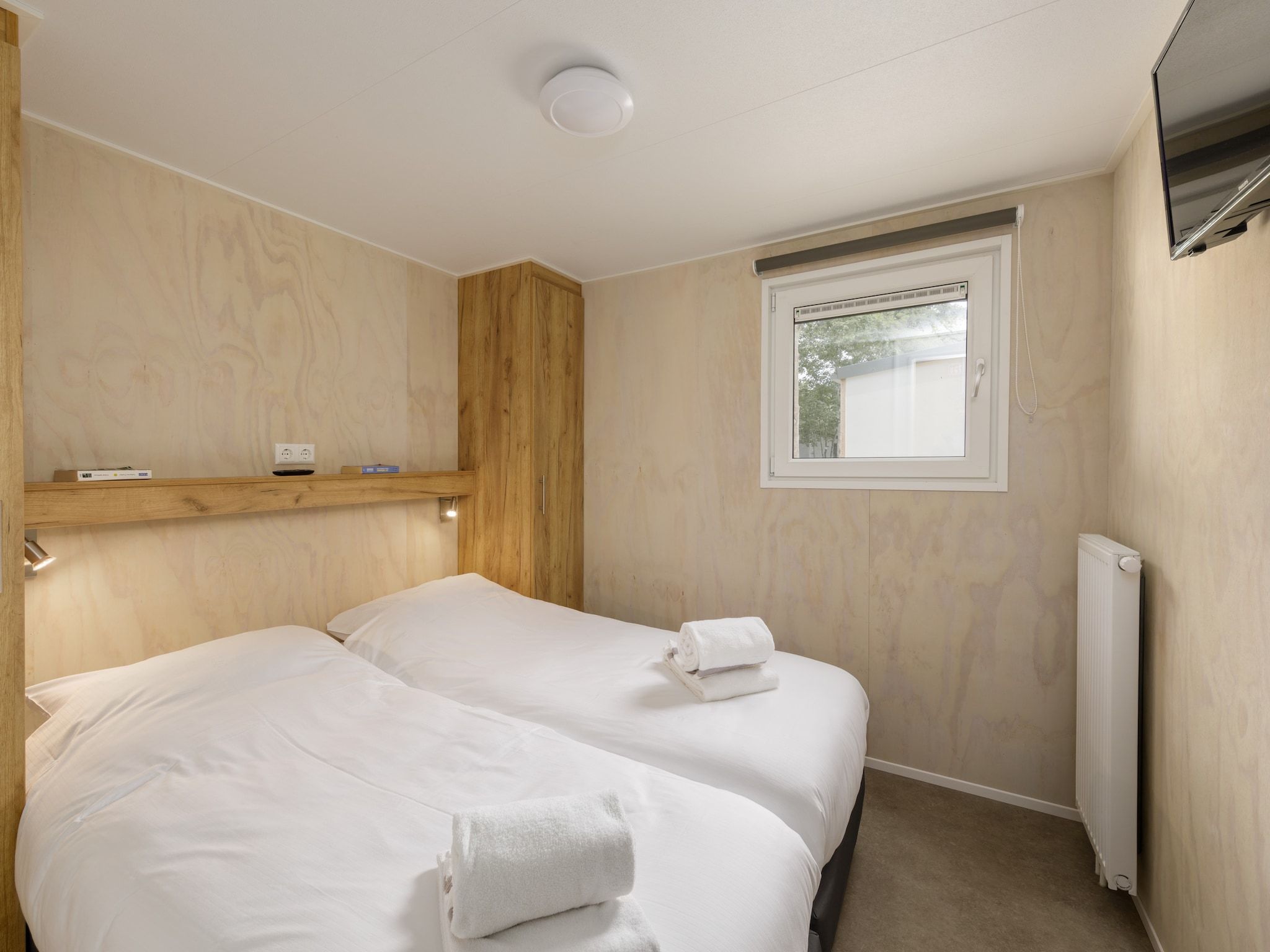 Een slaapkamer van Vakantiepark Kijkduin 11 in Den Haag