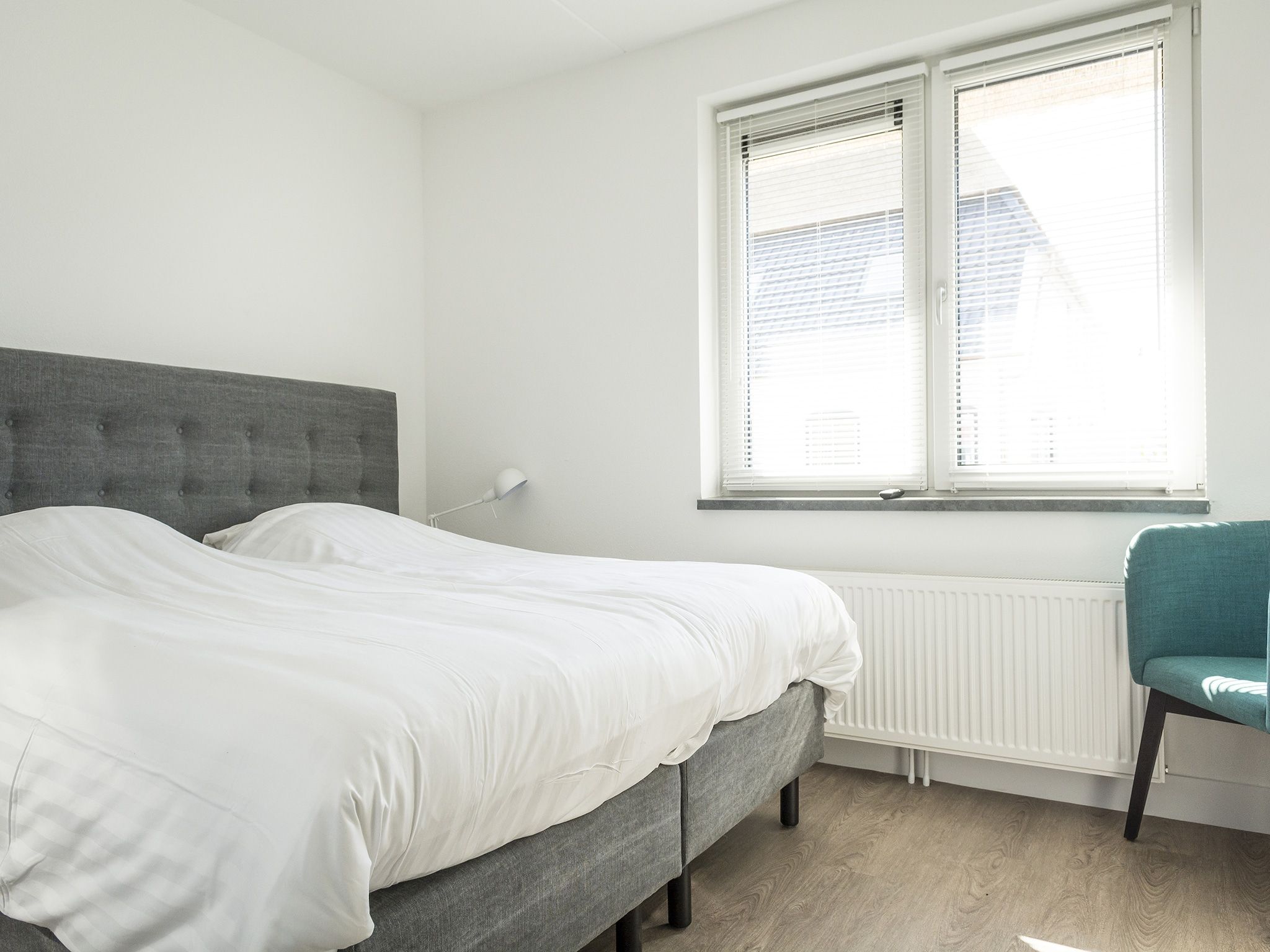 Een slaapkamer van Landhuis Bouwlust K in De Cocksdorp Texel