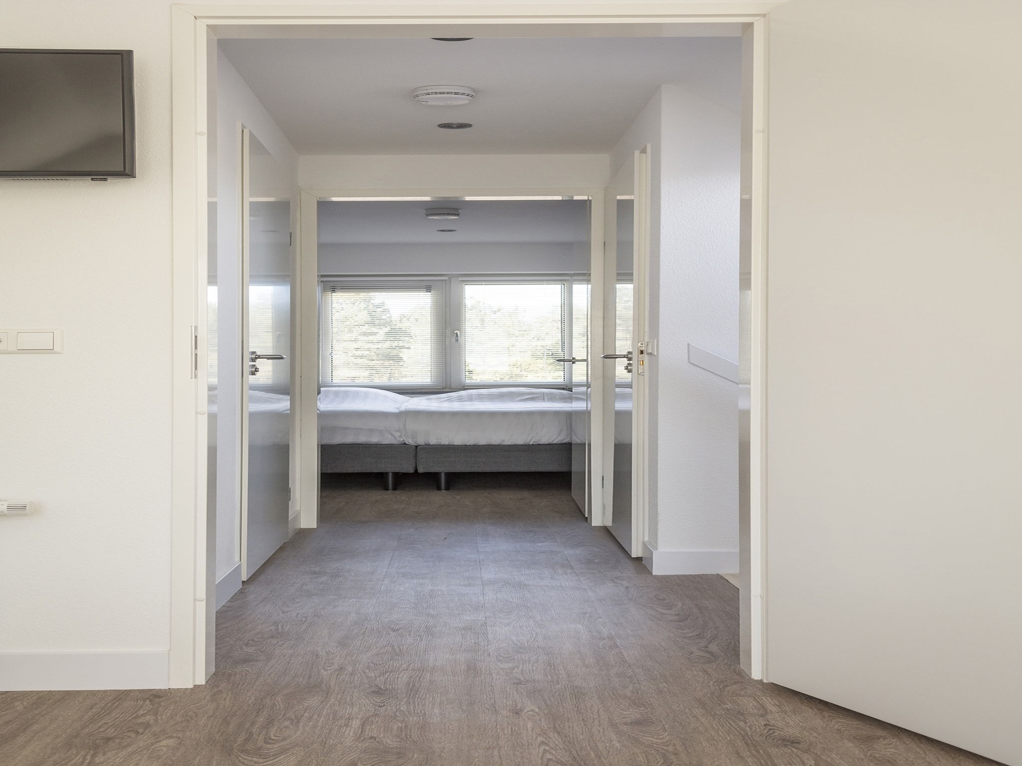 Een slaapkamer van Landhuis Bouwlust K in De Cocksdorp Texel