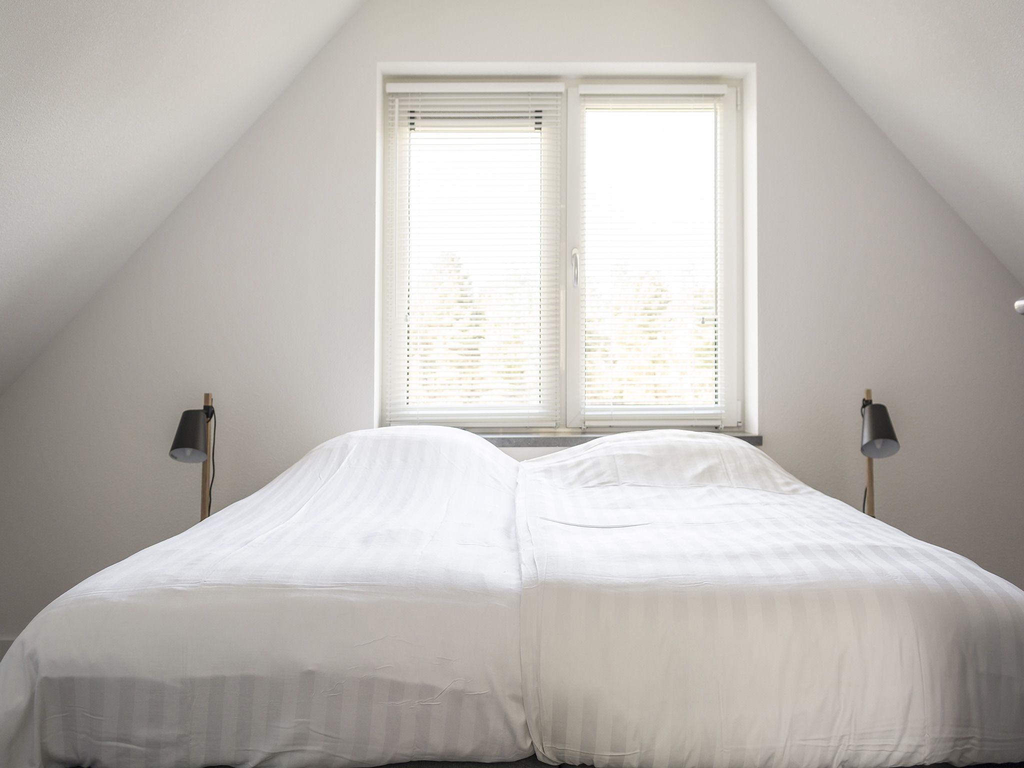 Een slaapkamer van Landhuis Bouwlust K in De Cocksdorp Texel
