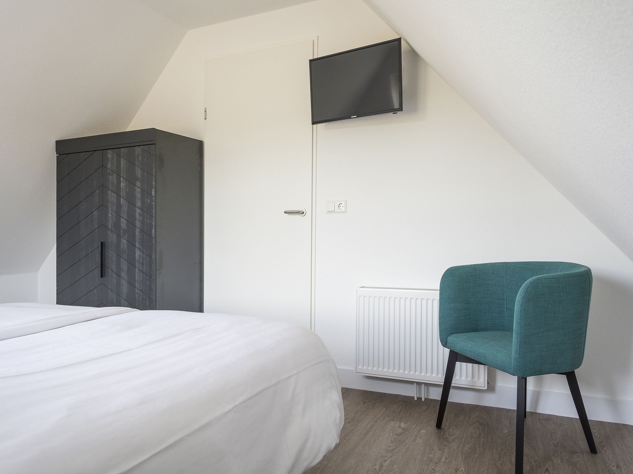 Een slaapkamer van Landhuis Bouwlust K in De Cocksdorp Texel