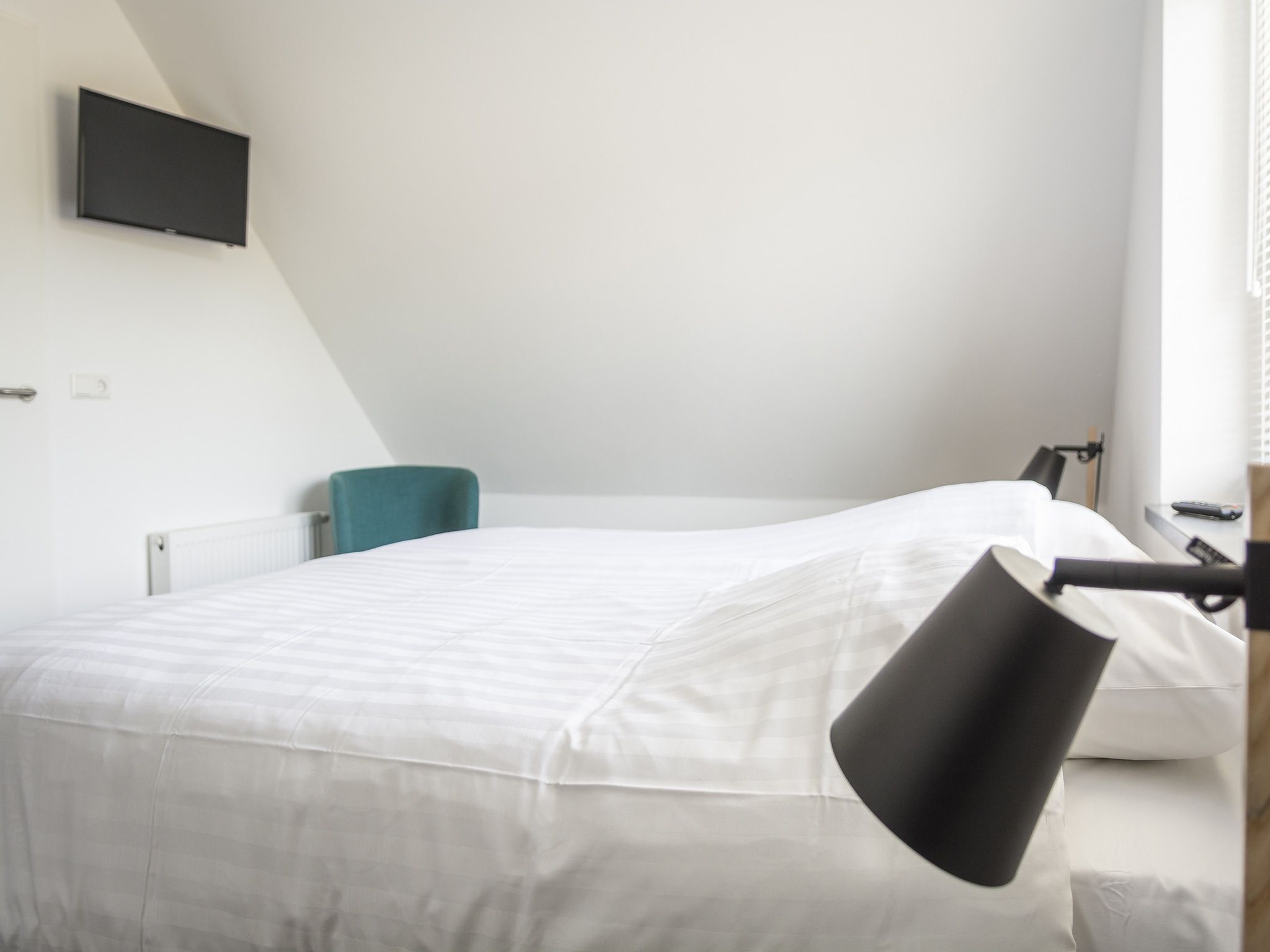 Een slaapkamer van Landhuis Bouwlust K in De Cocksdorp Texel