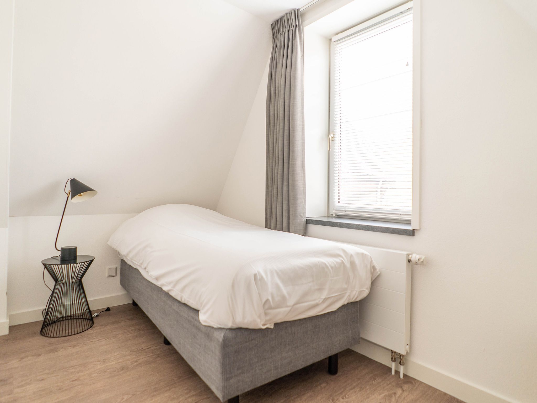 Een slaapkamer van Bungalow van der Linde D-8b in De Cocksdorp Texel