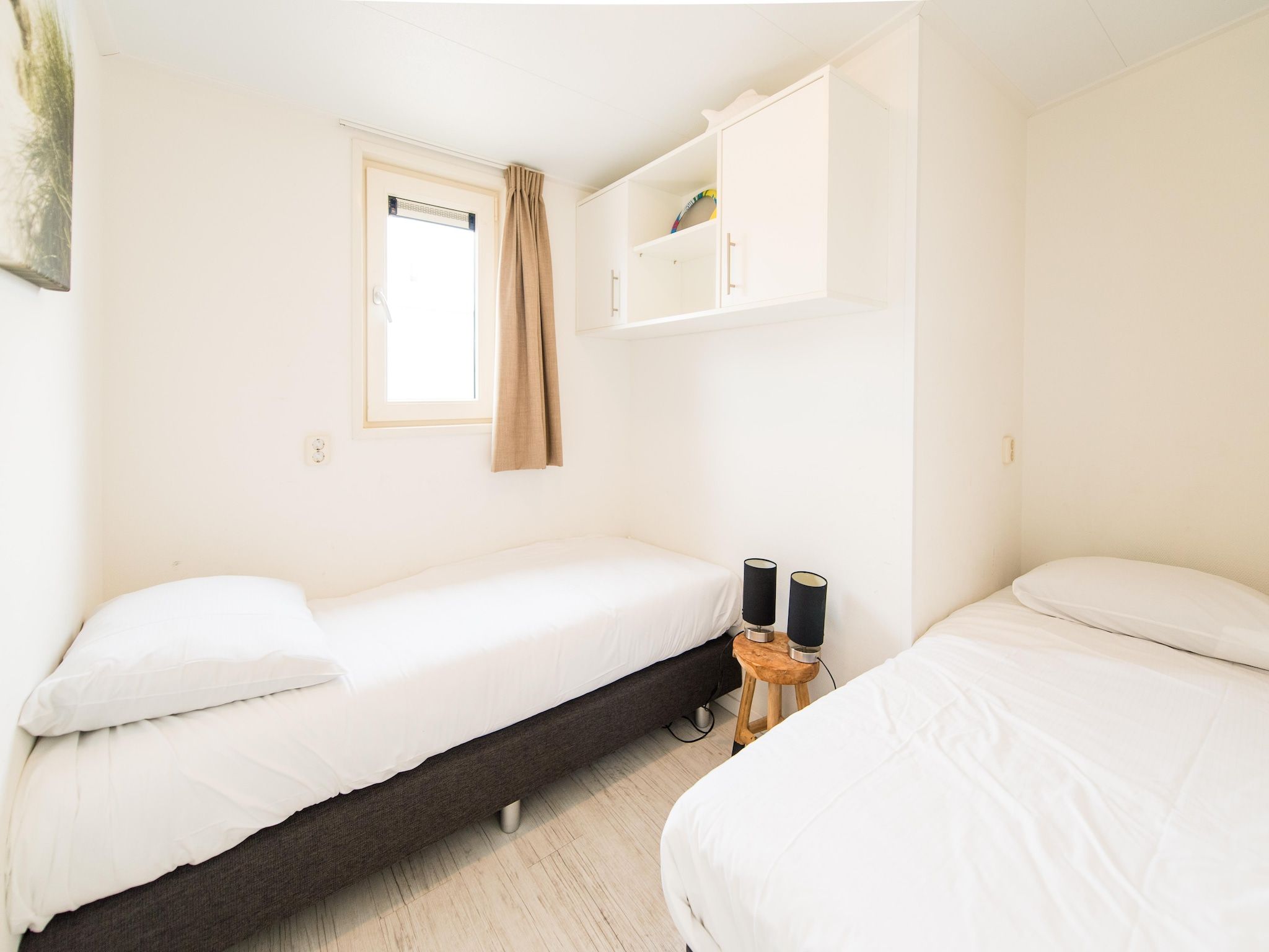 Een slaapkamer van Vakantiepark Boomhiemke 14 in Hollum