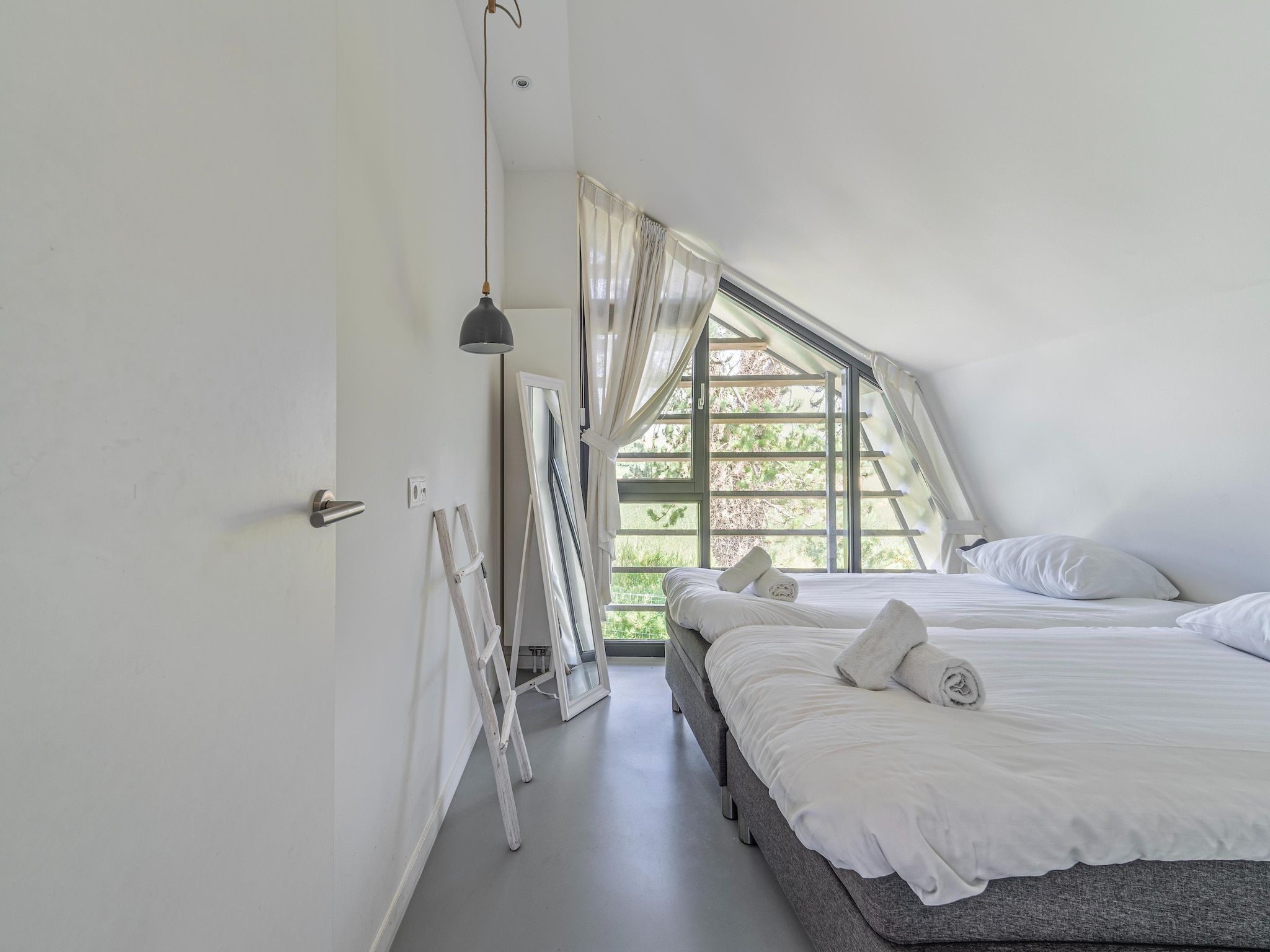 Een slaapkamer van Duinvilla in Egmond aan den Hoef