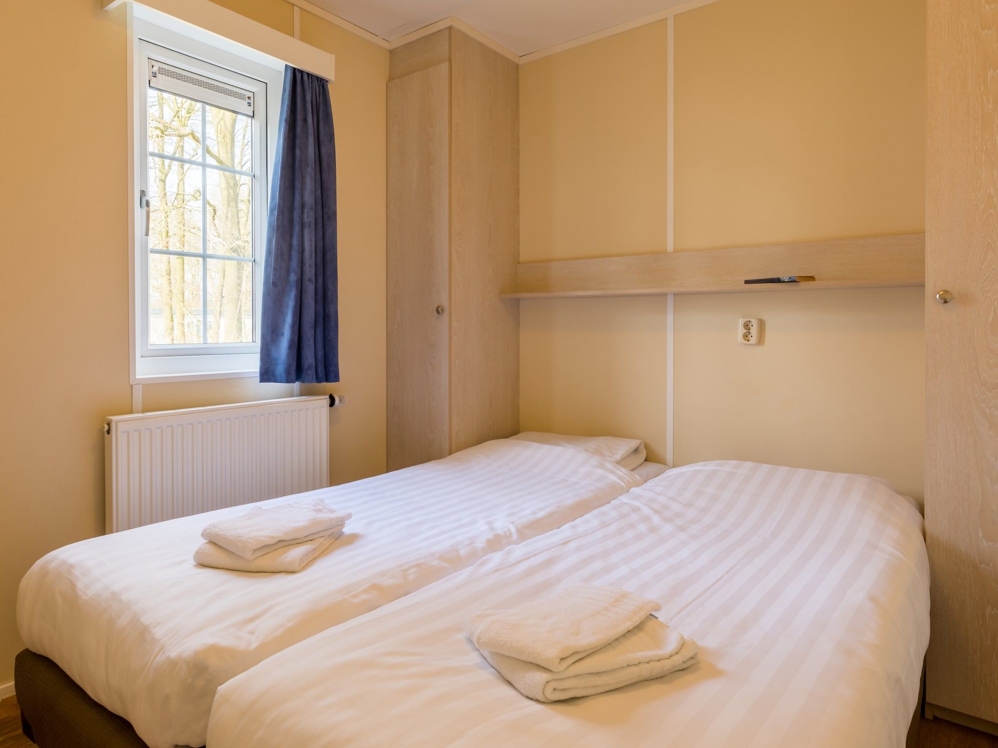 Een slaapkamer van Vakantiepark Hunzedal 14 in Borger