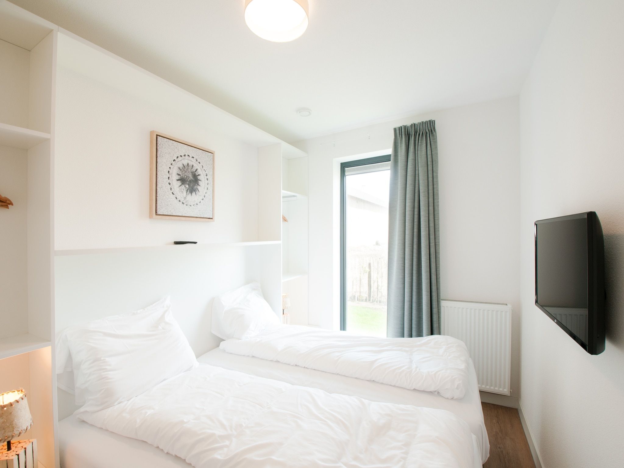 Een slaapkamer van Resort Waterrijk Oesterdam 13 in Tholen