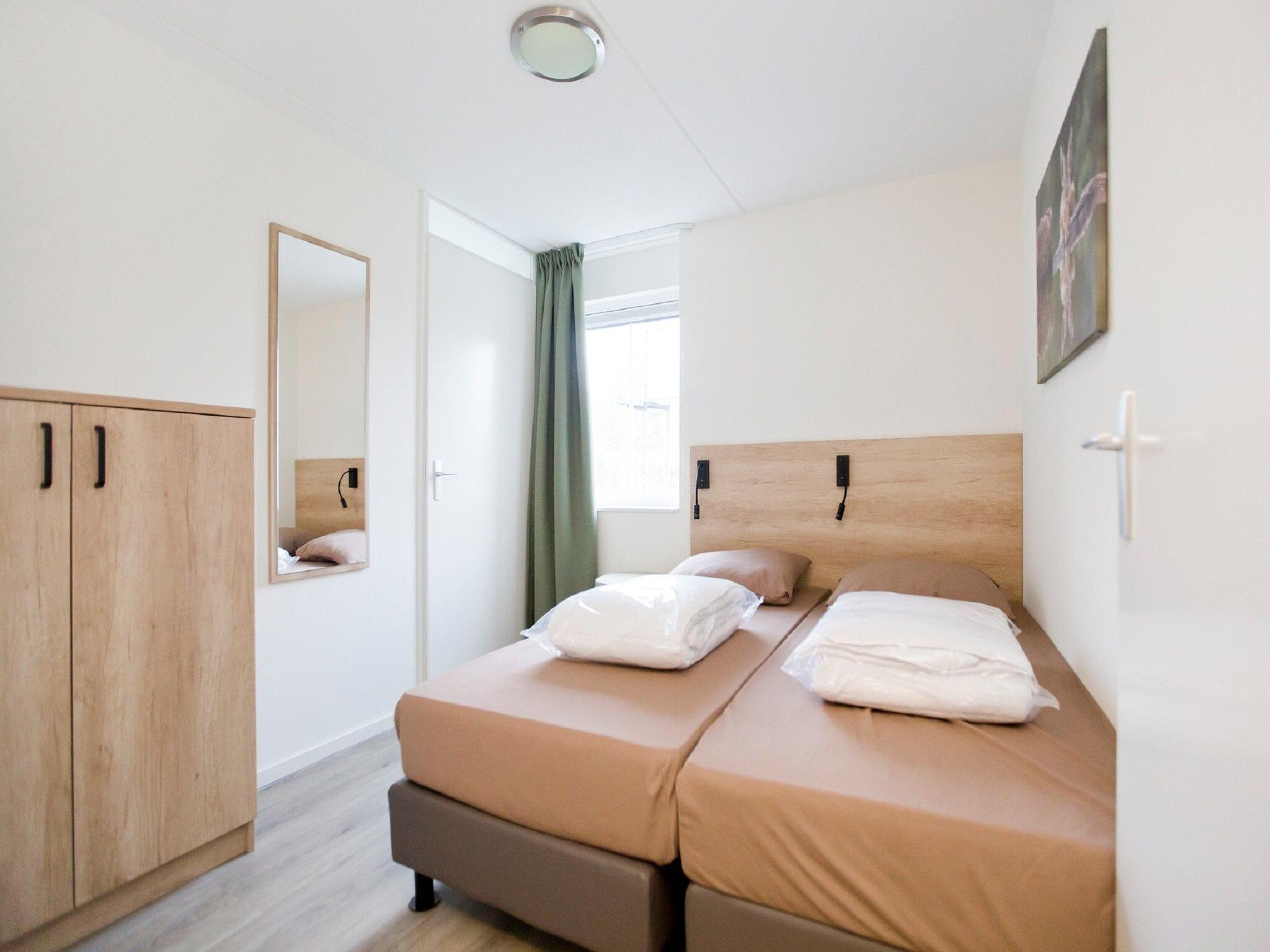 Een slaapkamer van Landgoed De IJsvogel 9 in Voorthuizen