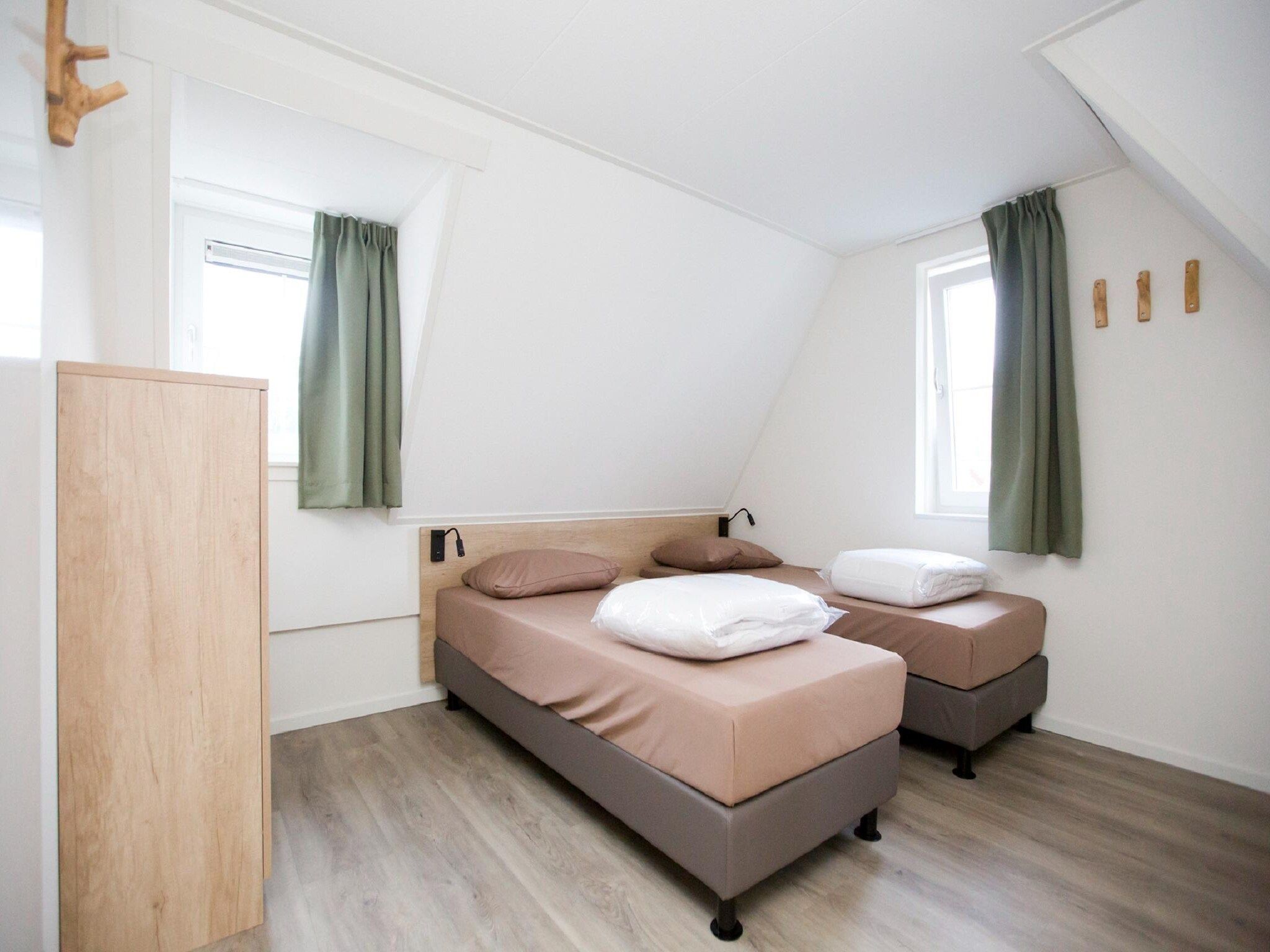 Een slaapkamer van Landgoed De IJsvogel 9 in Voorthuizen