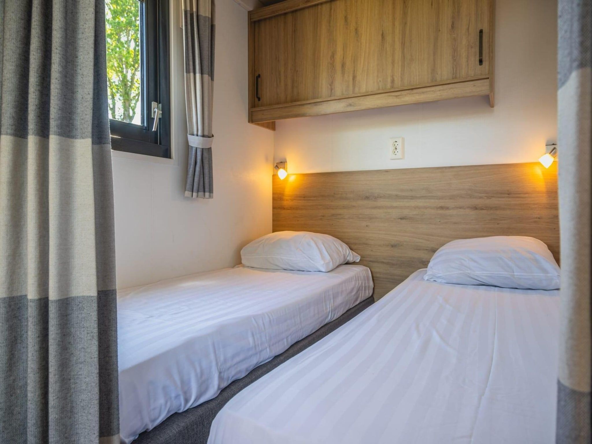 Een slaapkamer van Tiny Lodge  4 personen in West-Graftdijk