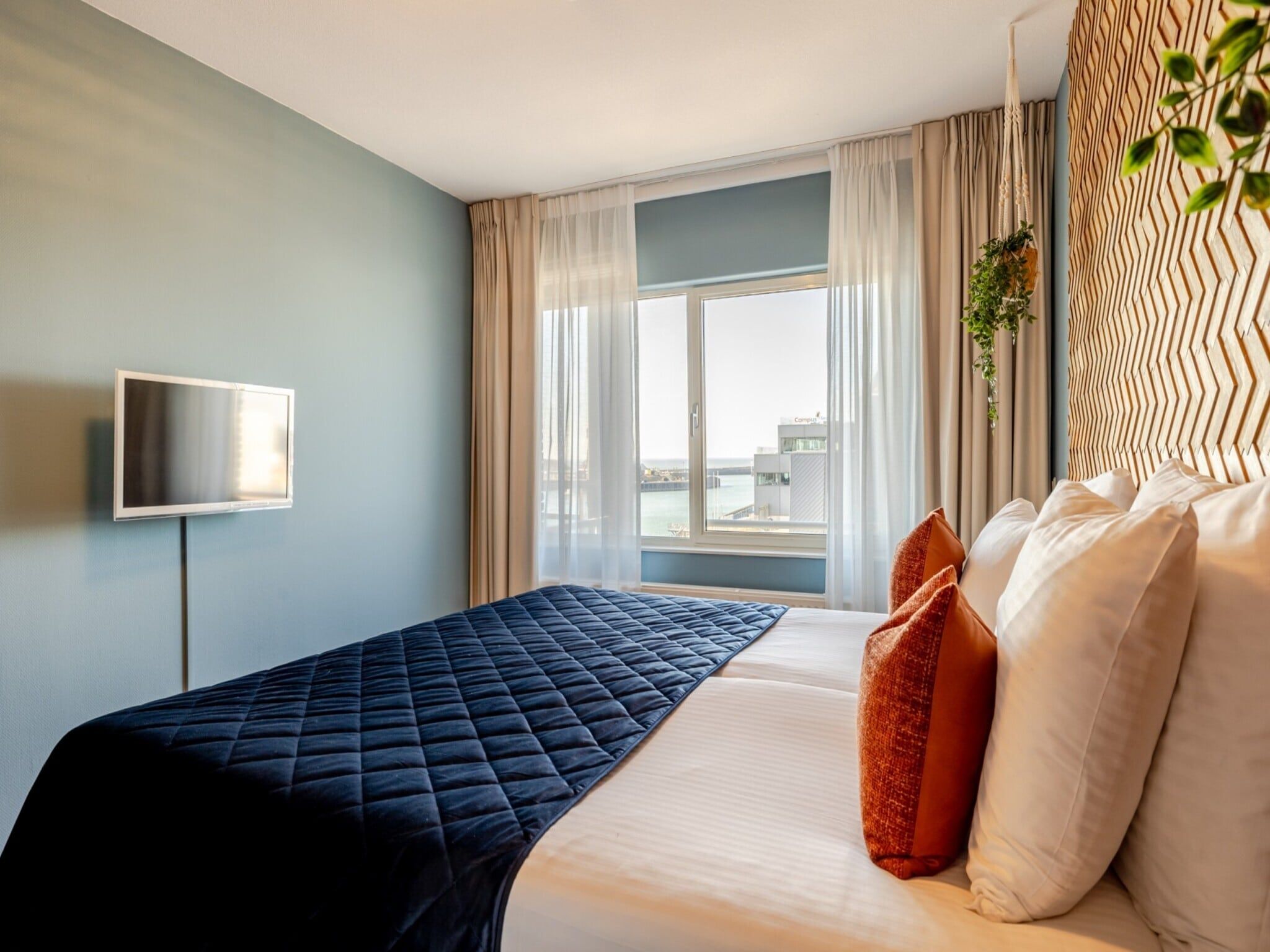 Een slaapkamer van Scheveningen Harbour 10B in Den Haag