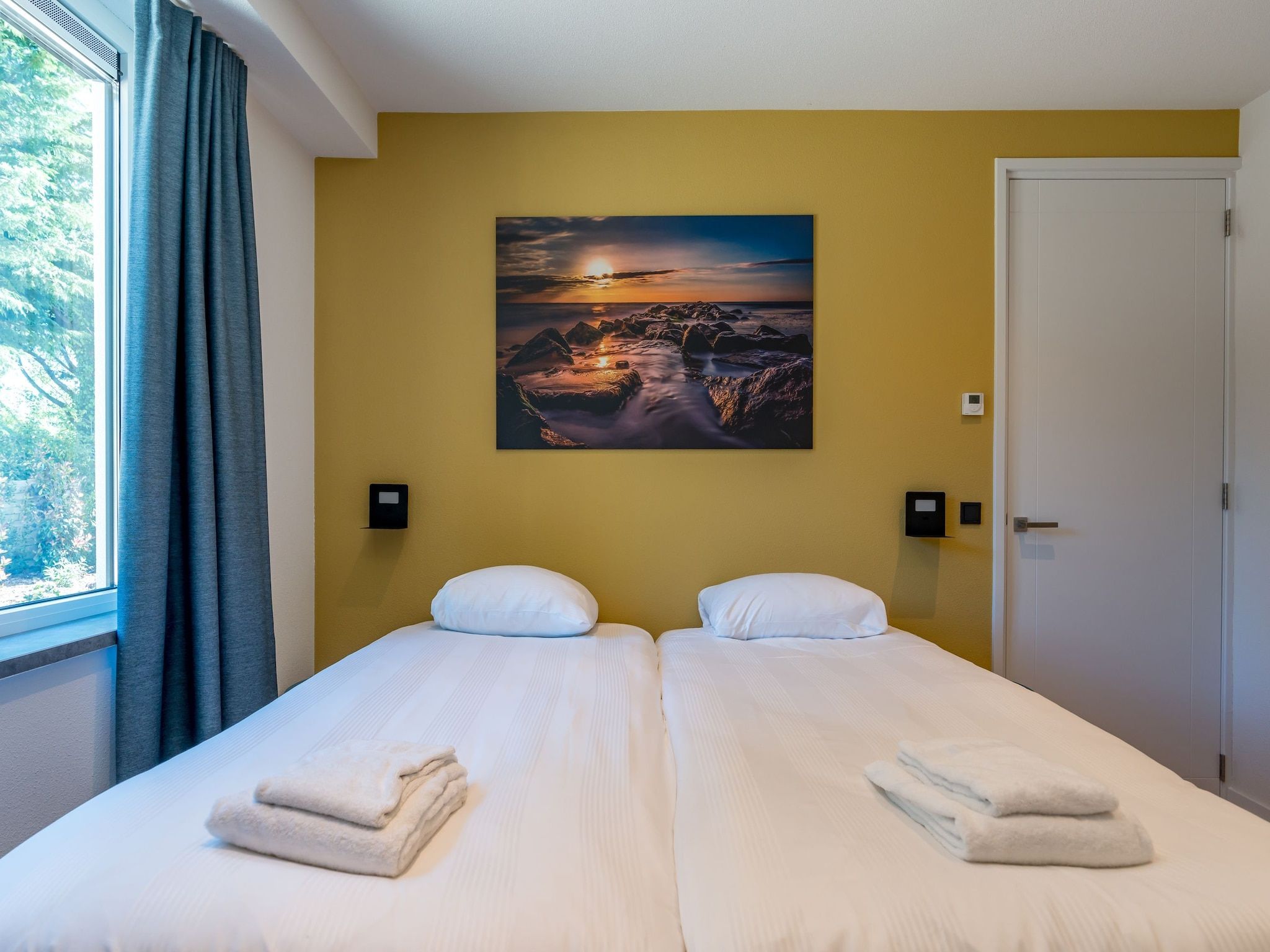 Een slaapkamer van De Grauwe Kiekendief Wellness in Den Burg