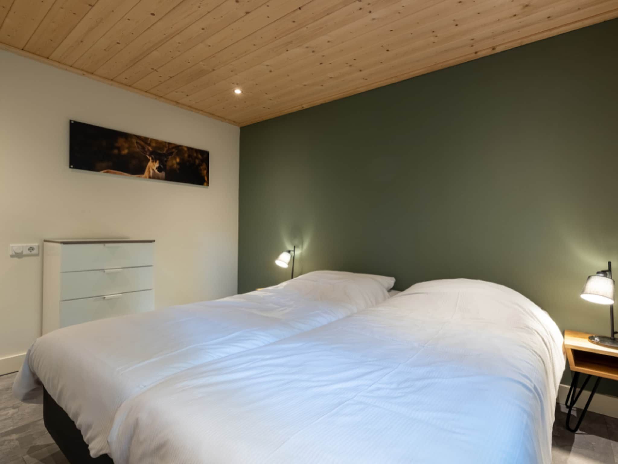 Een slaapkamer van Vakantiepark De Rimboe & De Woeste Hoogte 18 in Hoenderloo