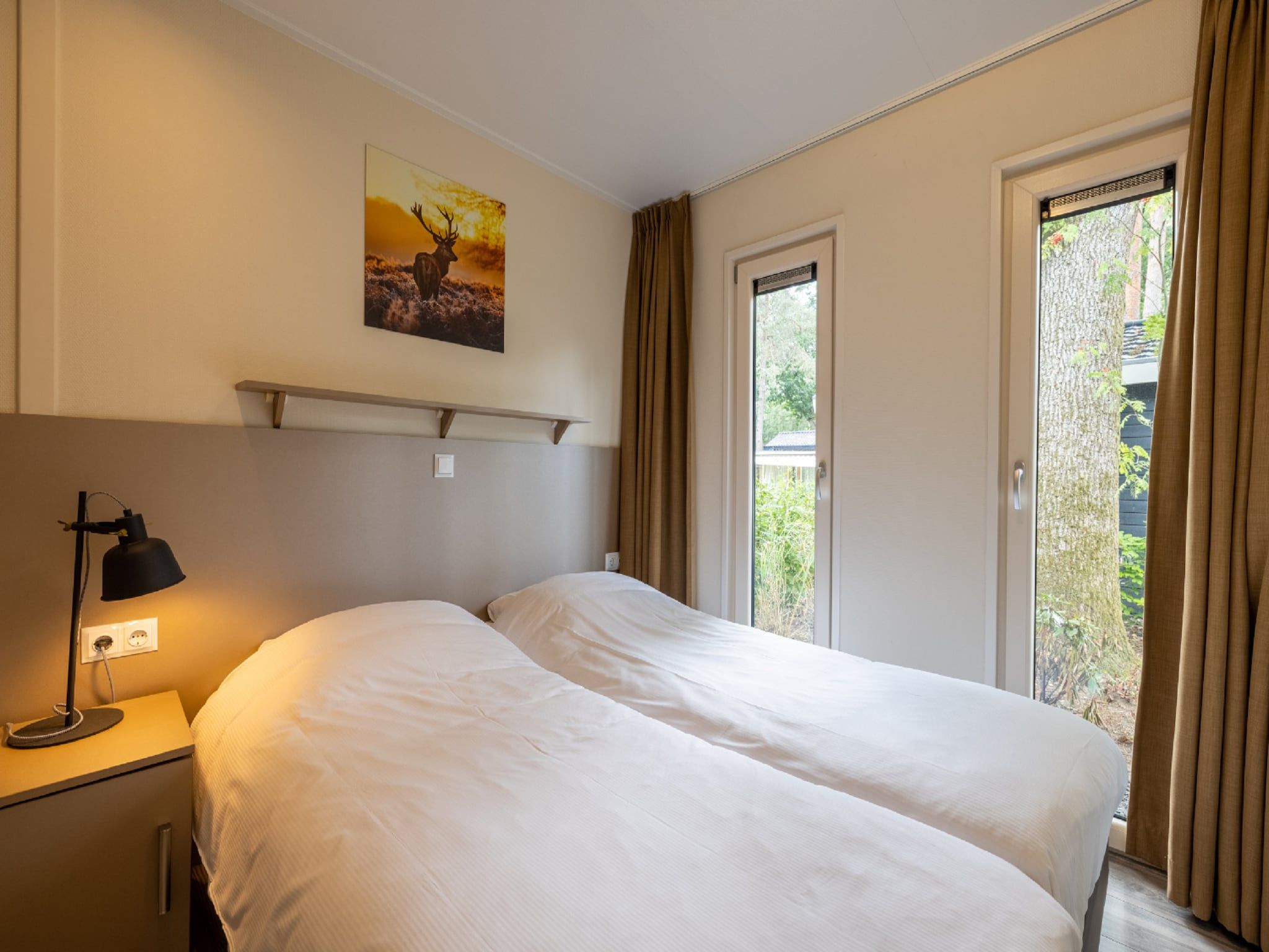 Een slaapkamer van Vakantiepark De Rimboe & De Woeste Hoogte 20 in Hoenderloo