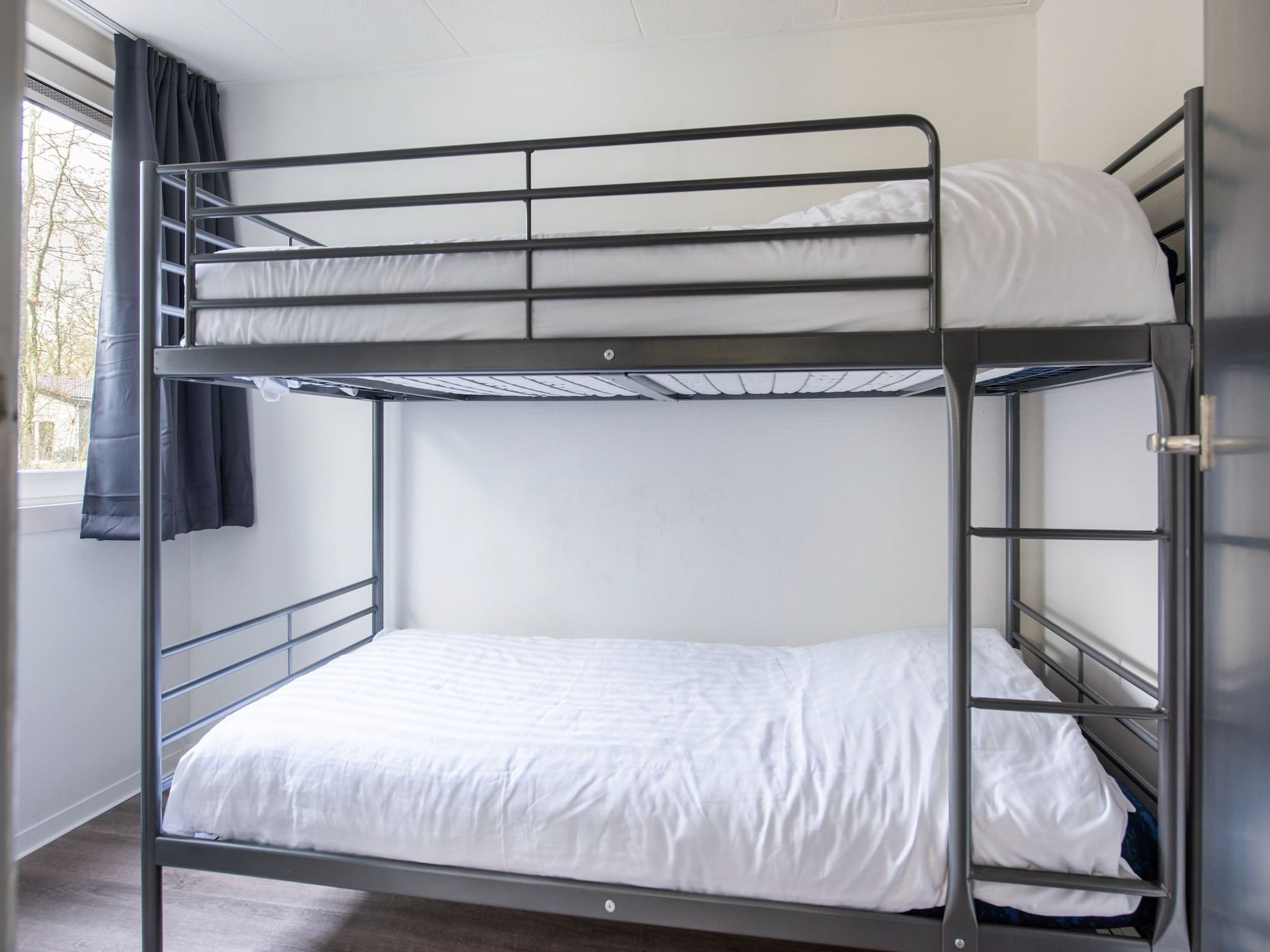 Een slaapkamer van Vakantiepark de Berkenhorst 11 in Kootwijk