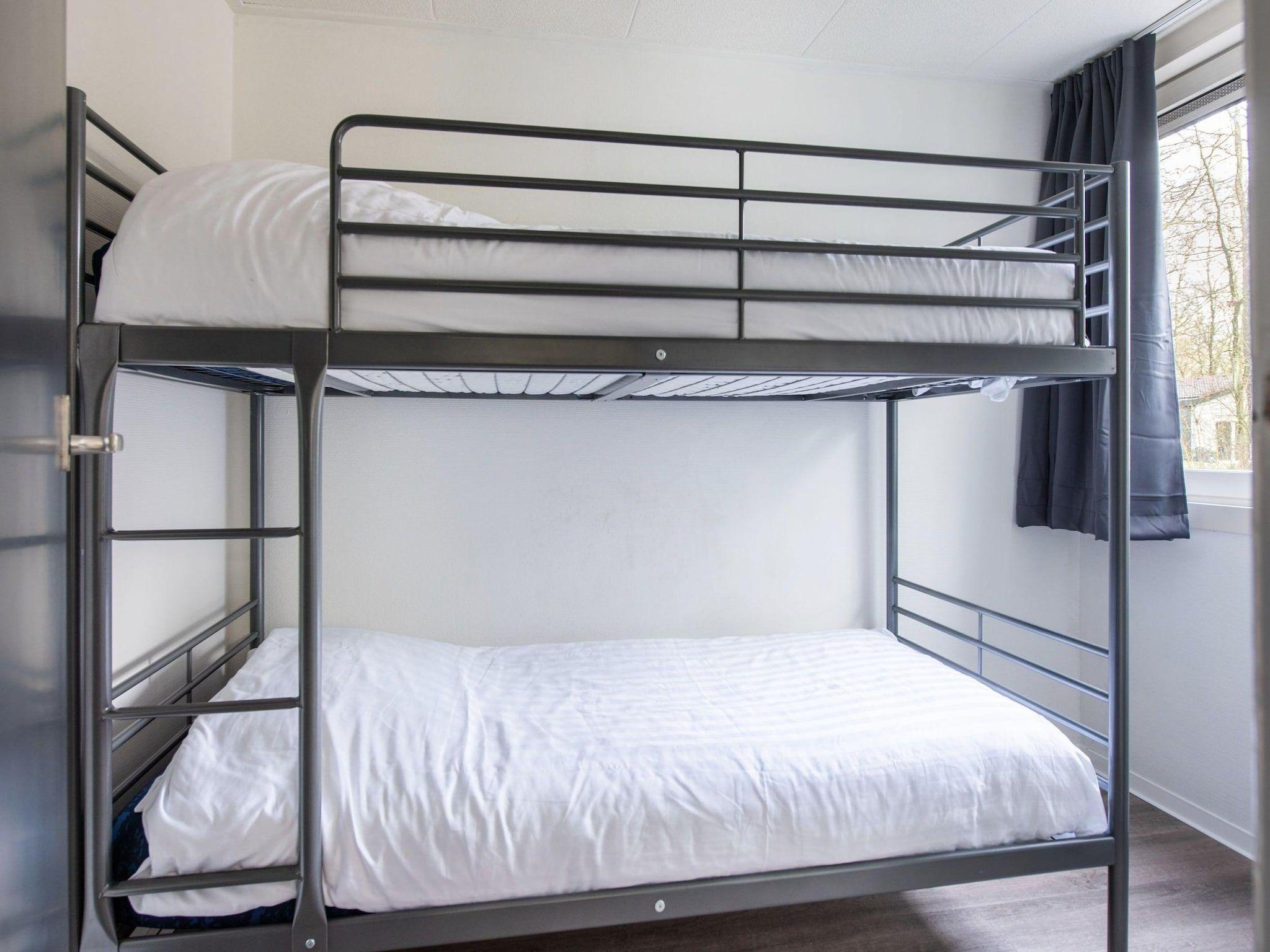 Een slaapkamer van Vakantiepark de Berkenhorst 11 in Kootwijk