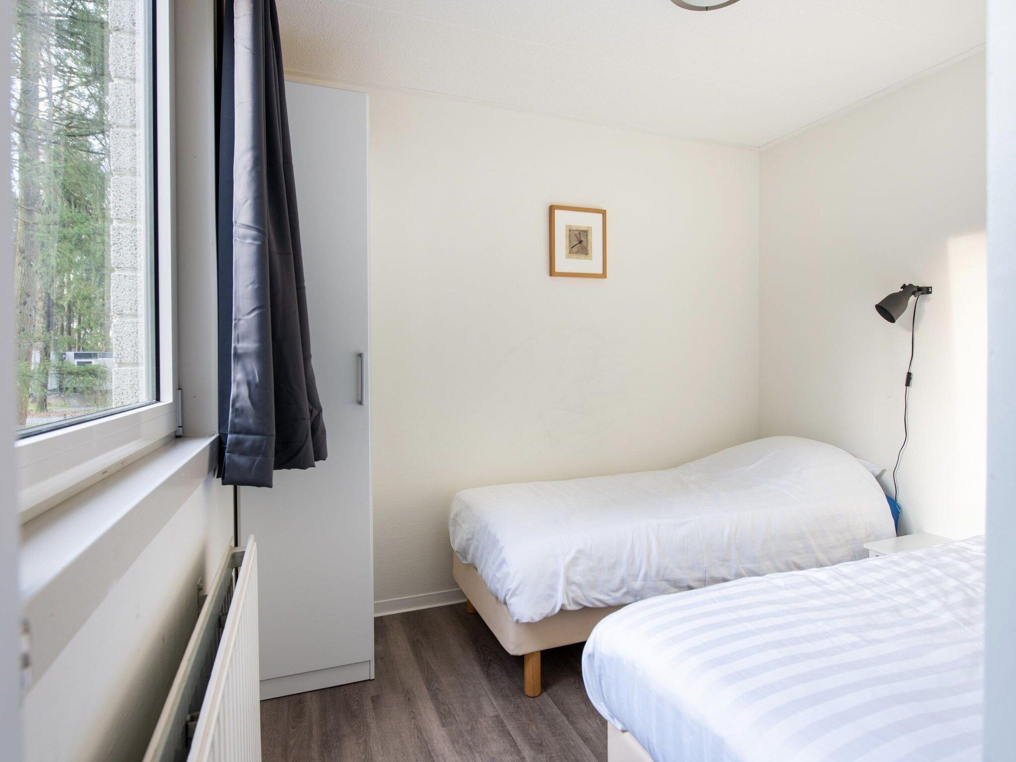 Een slaapkamer van Vakantiepark de Berkenhorst 11 in Kootwijk