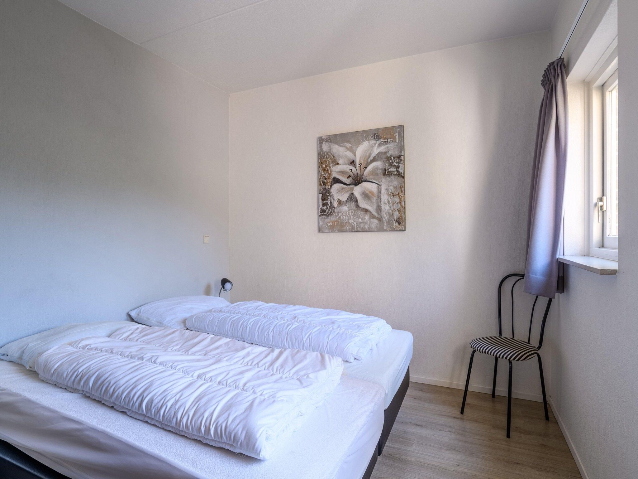 Een slaapkamer van Vakantiepark Emslandermeer 13 in Vlagtwedde